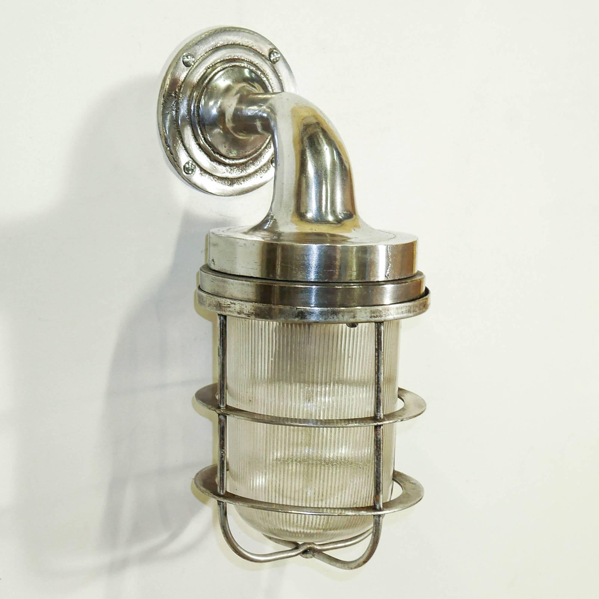 Old industrial wall light for outside, in die-cast aluminium, picked and polished, thick reeded glass.

 