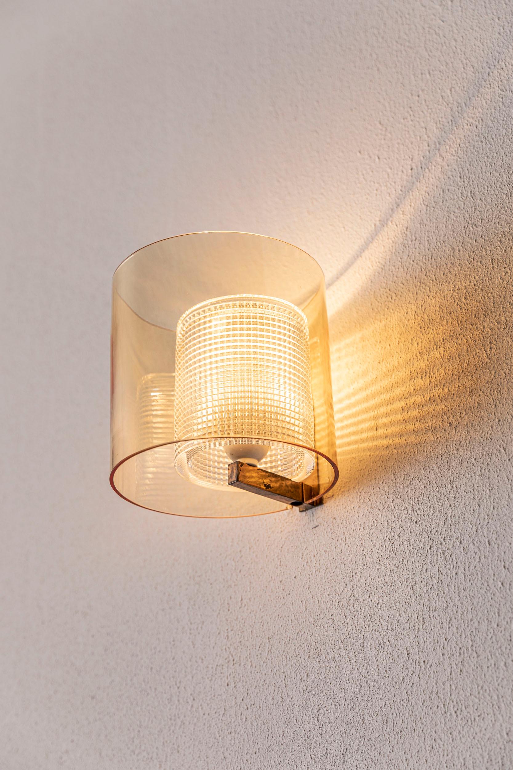 Charming single glass and brass wall light attributed to Carl Fagerlund for Orrefors.
  