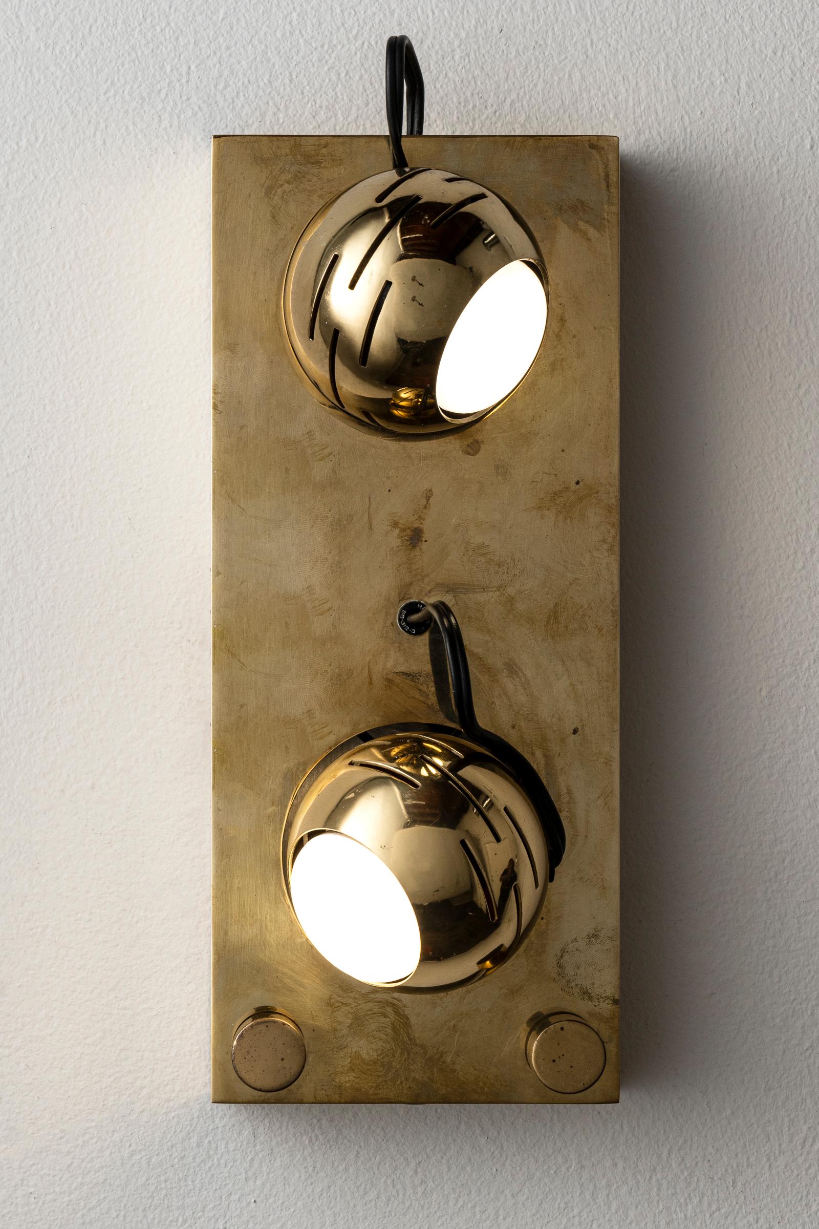 Eyeball Wall lamp by Angelo Lelli for Arredoluce. Designed and manufactured in Italy, circa 1960's. Brass. Rewired for U.S. standards. Globes adjust to various positions. We recommend two E27 6ow maximum bulbs. Bulbs not included. Please note, we