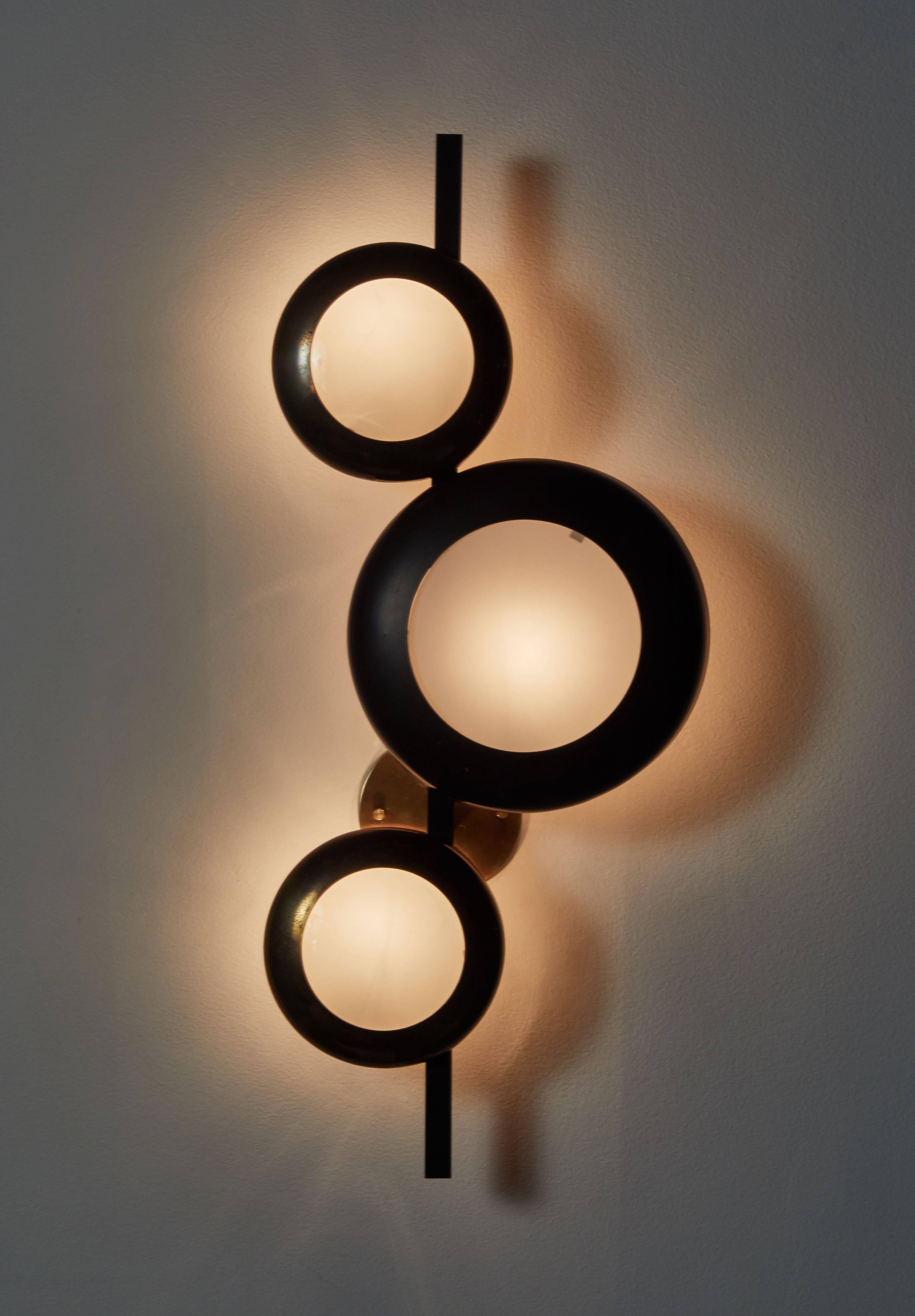 Wall light by Oscar Torlasco. Designed and manufactured in Italy for Lumi, circa 1950s. Brass and brushed satin glass. Rewired for US junction boxes. Takes three European E27 30w maximum bulbs.
