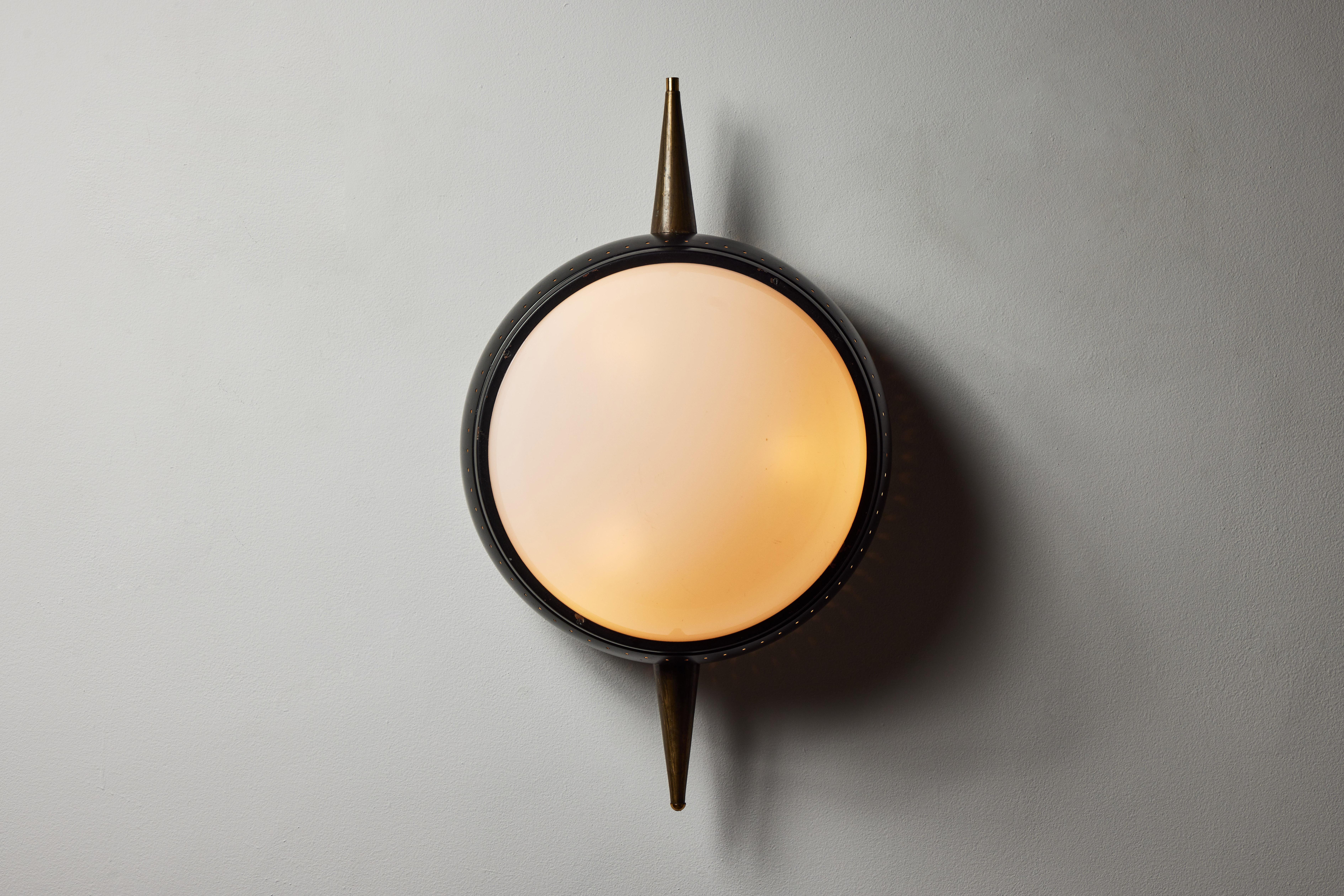 Wall light by Oscar Torlasco. Designed and manufactured in Italy, circa 1950s. Opal glass diffusers, painted metal, brass. Wired for U.S. standards. We recommend three E14 25w maximum bulbs. Bulbs provided as a one time courtesy.