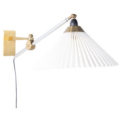 Wall light in brass with pleated shade by Le Klint