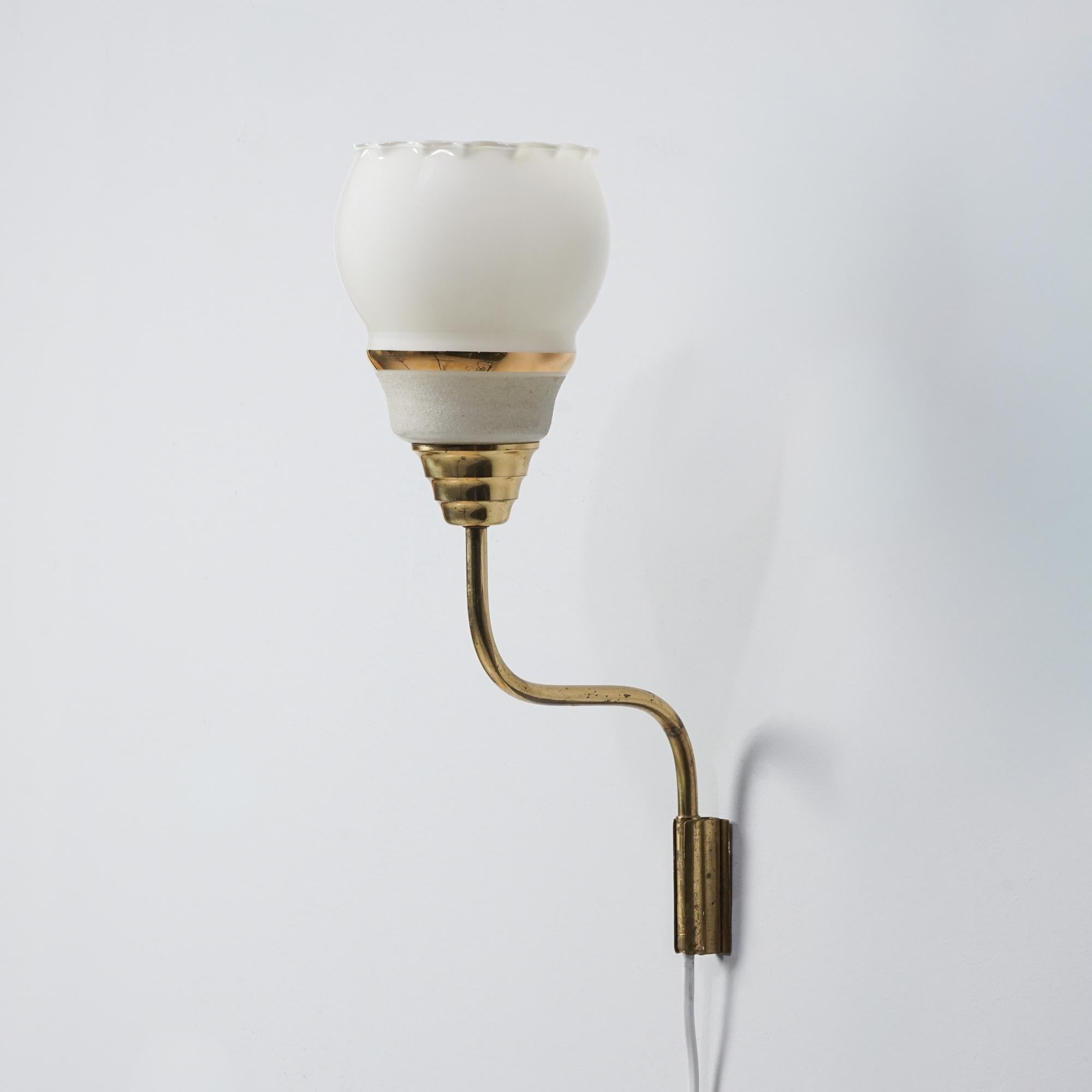 Wall light, manufactured by Itsu, Finland, 1960s. Brass frame, opaline glass shade. Good vintage condition, minor patina consistent with age and use. 