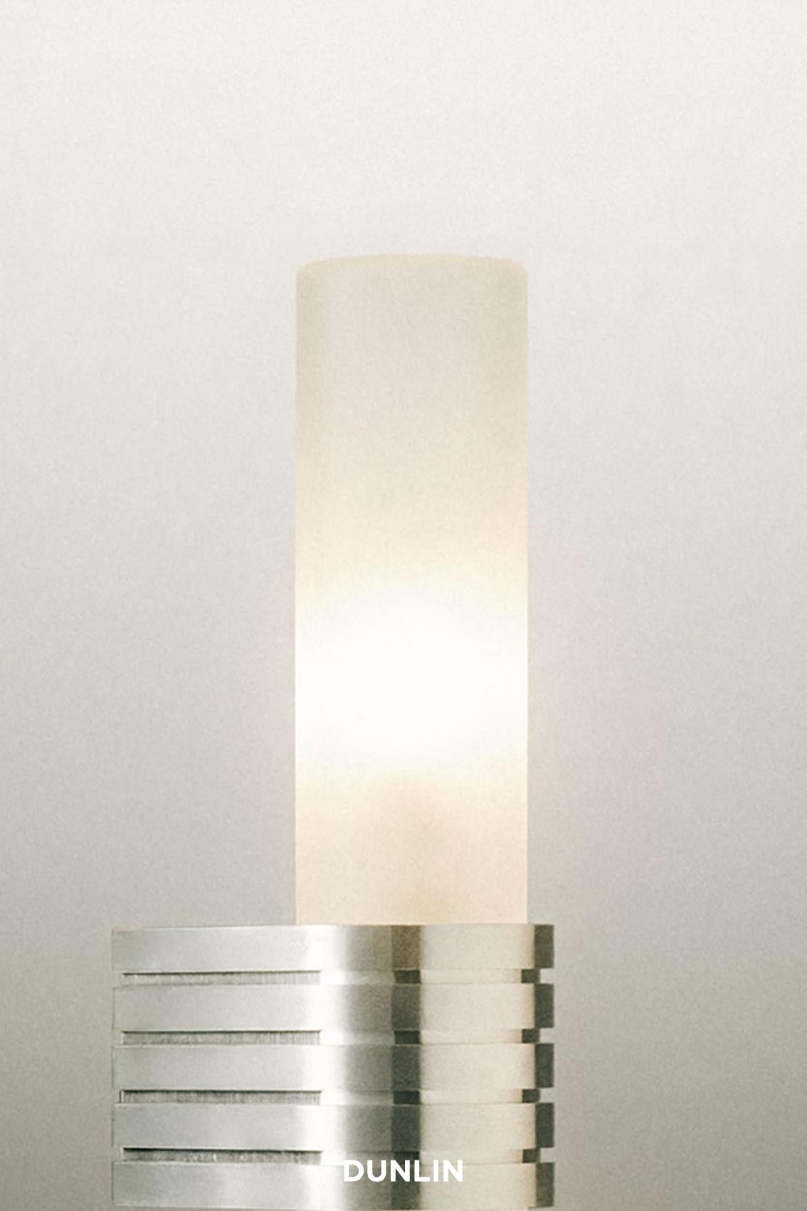Made by hand exclusively for Dunlin
Height: 170mm.
Depth from wall: 75mm.
Finishes: Available in Polished Aluminium and Weathered Brass
12V G4 Phillips Professional lamp.
210lm 
Remote driver required, supplied. 
Dimmable.
100% Handmade all items