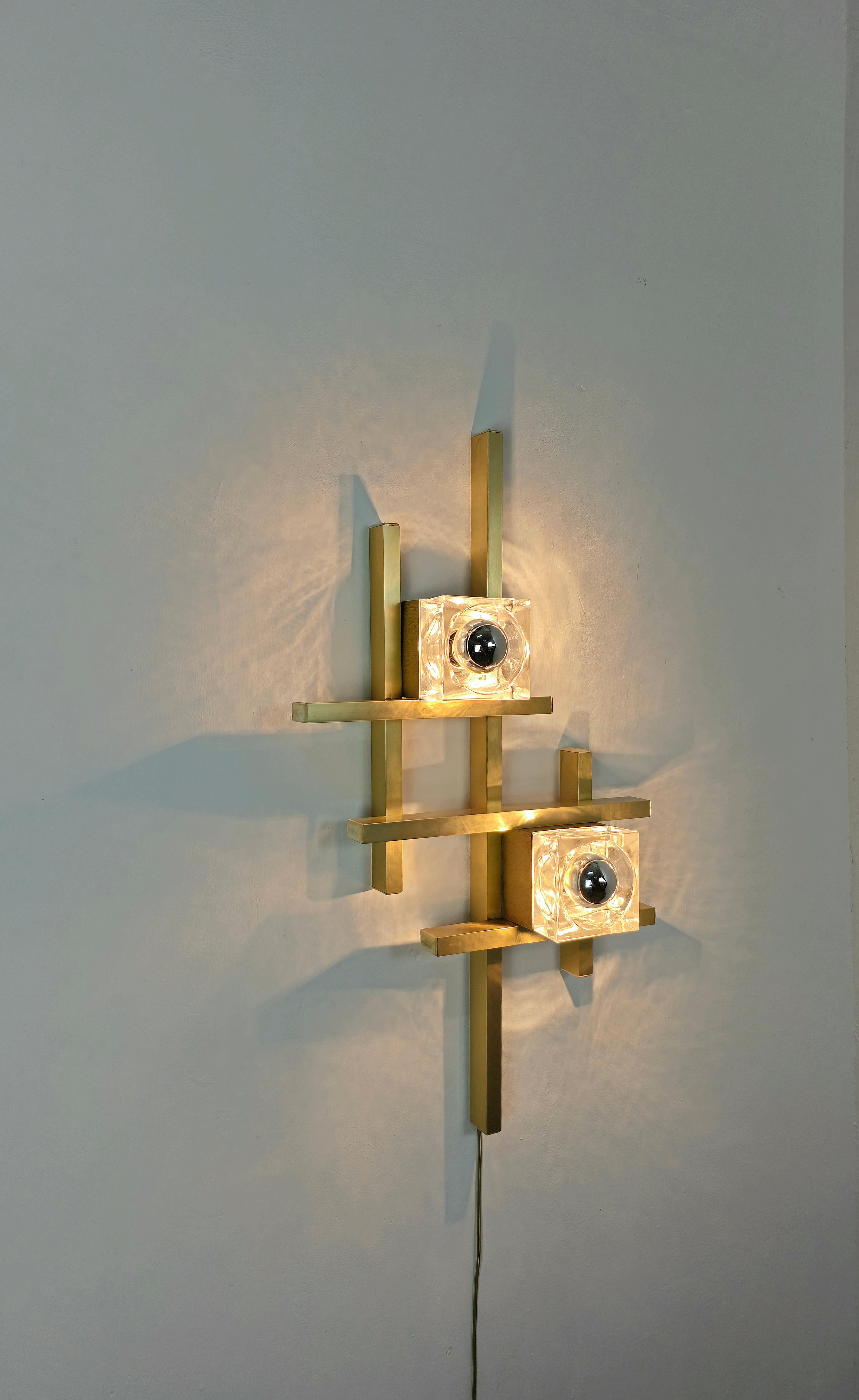 Wall lamp designed by the well-known designer Gaetano Sciolari and produced in Italy in the 70s.
Sculptural wall lamp in golden aluminum with two double glass and cubic-shaped glasses.