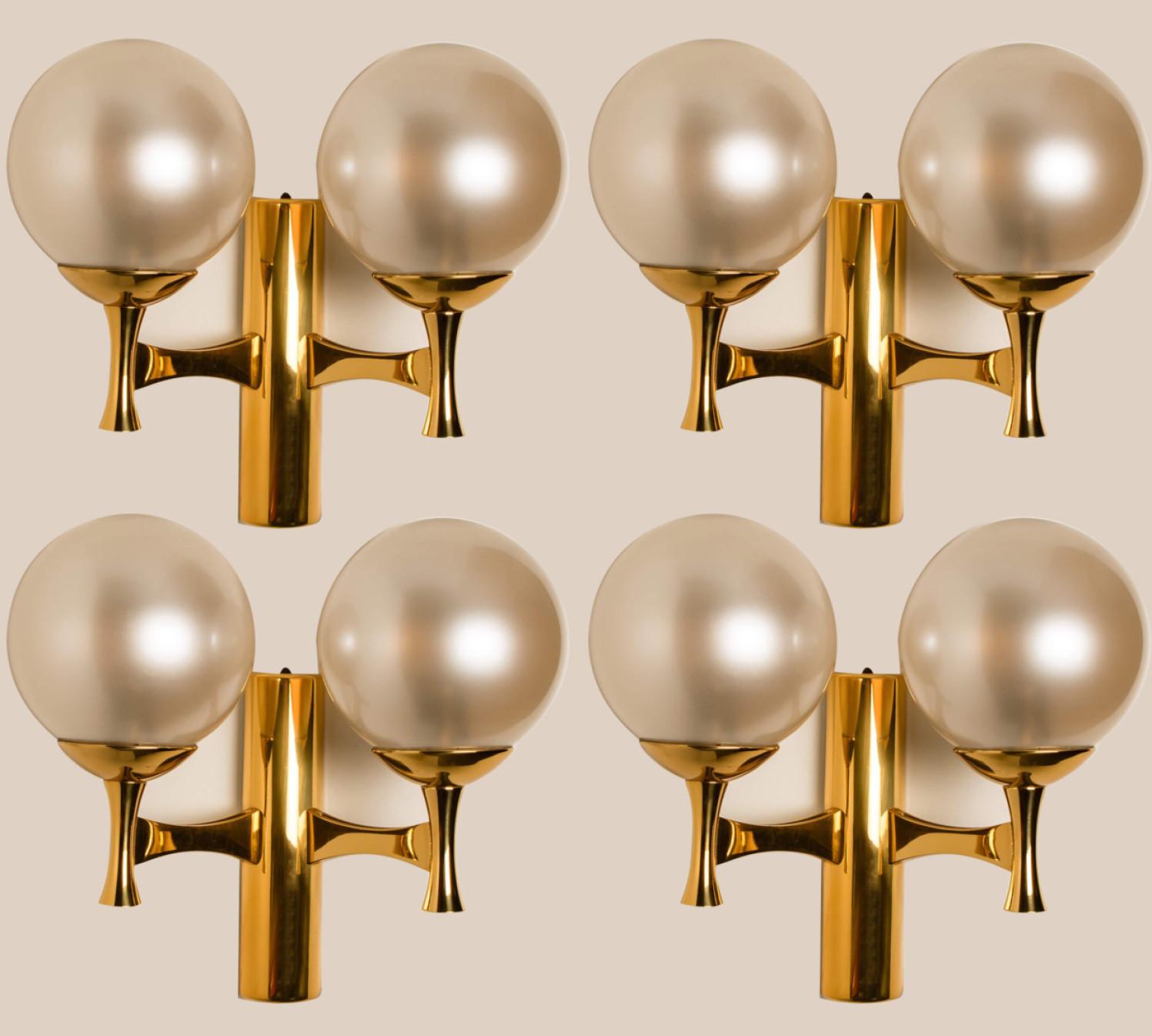 1 of the 4  brass and opaline glass wall lights, Europe, 1960s.

The wall light consists 2 opaline glass spheres. Due the combination of materials these lights will create a beautiful warm and diffuse lights. Designed in the style of Sciolari.

In