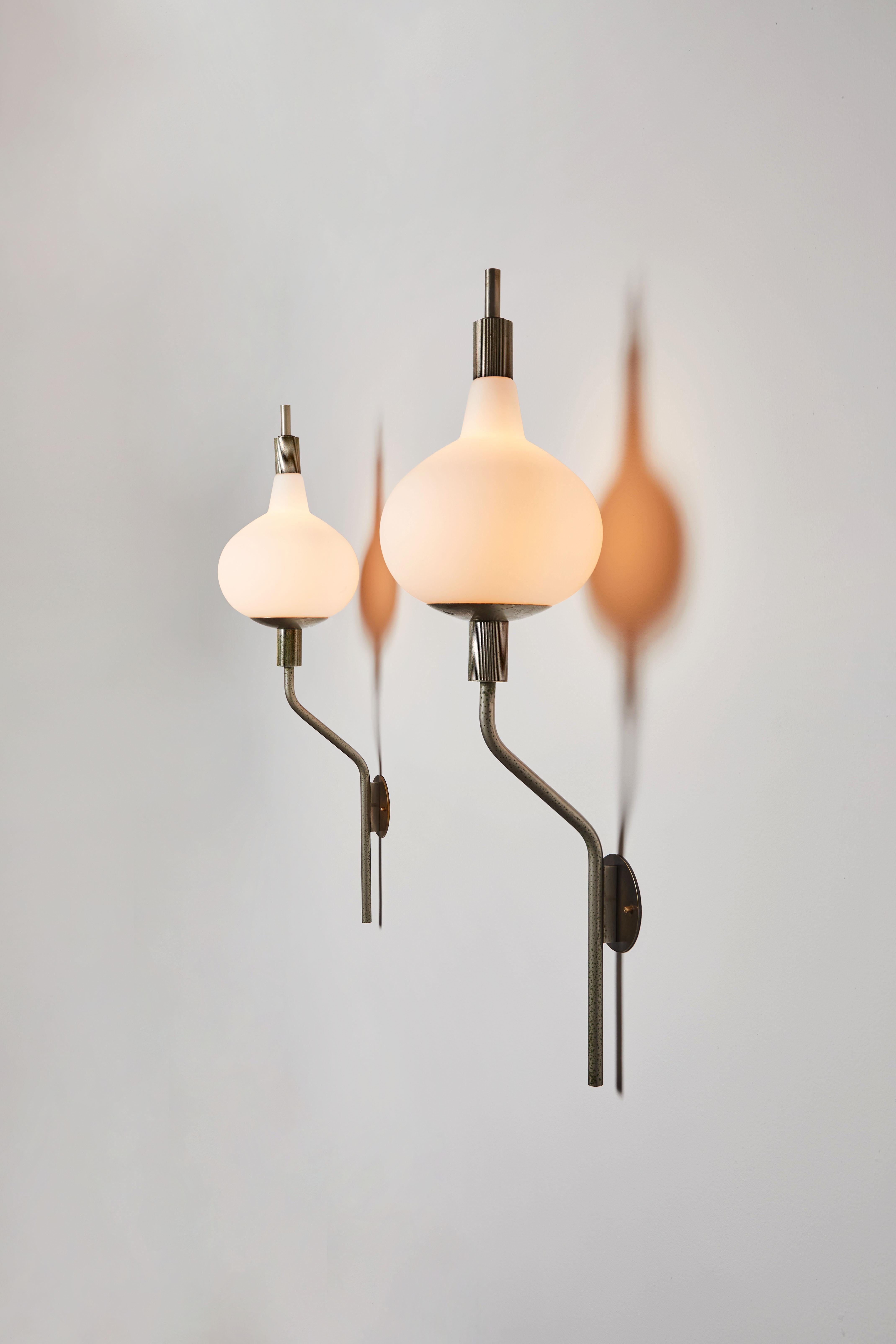 Wall lights by Candle. Manufactured in Italy, circa 1960s. Brushed satin glass diffusers, satin nickel armature, custom backplates. Rewired for U.S. standards. We recommend three E27 40w maximum candelabra bulbs per light. Bulbs provided as a one