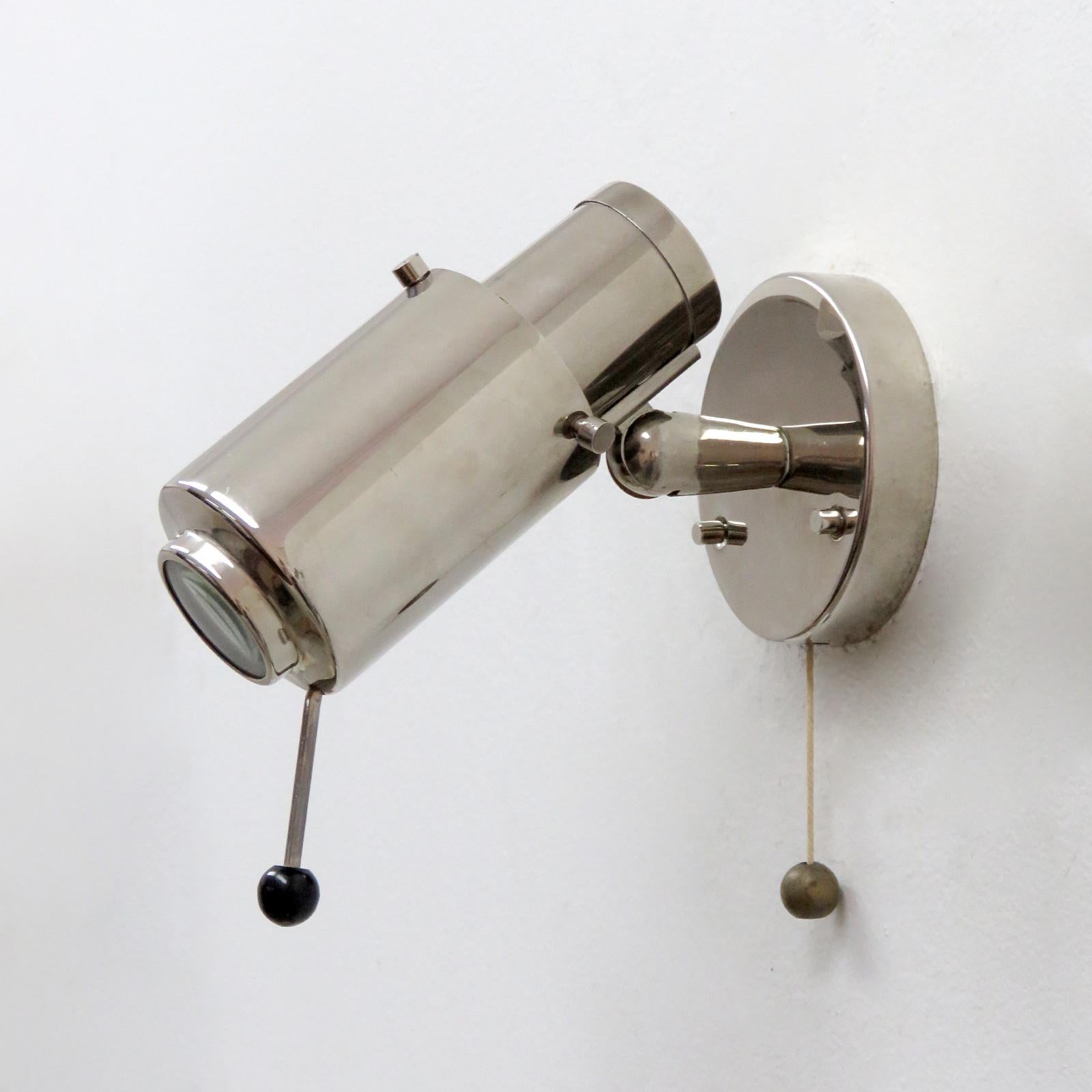 Pair of nickel-plated wall lights by Jacques Biny for Lita, magnifying lens, handle to adjust and on/off pull switch, marked.