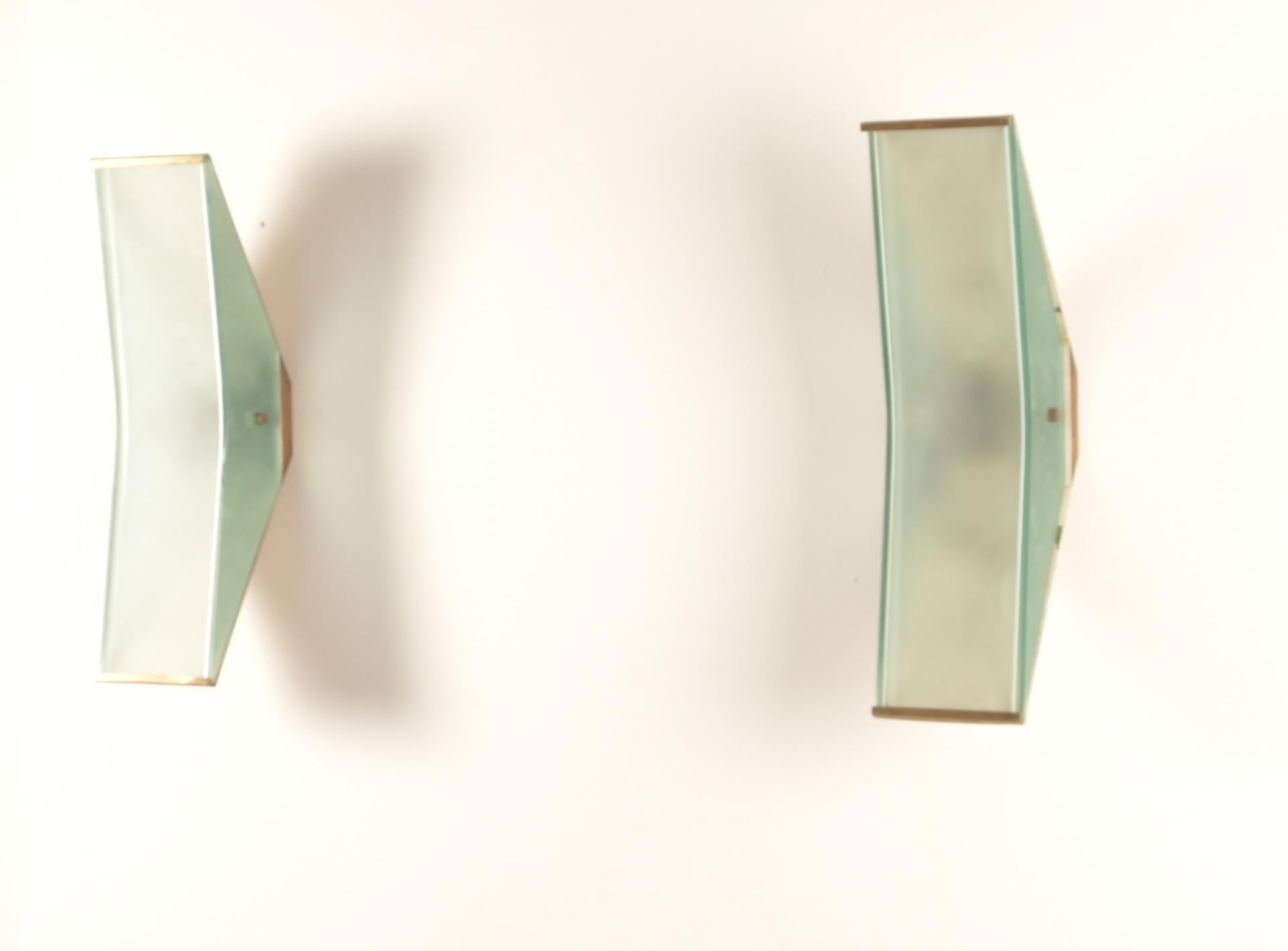 Wall lights, model no. 2135,1960s
Opaque glass, opaque colored glass, brass.
Manufactured by Fontana Arte, Milan, Italy.