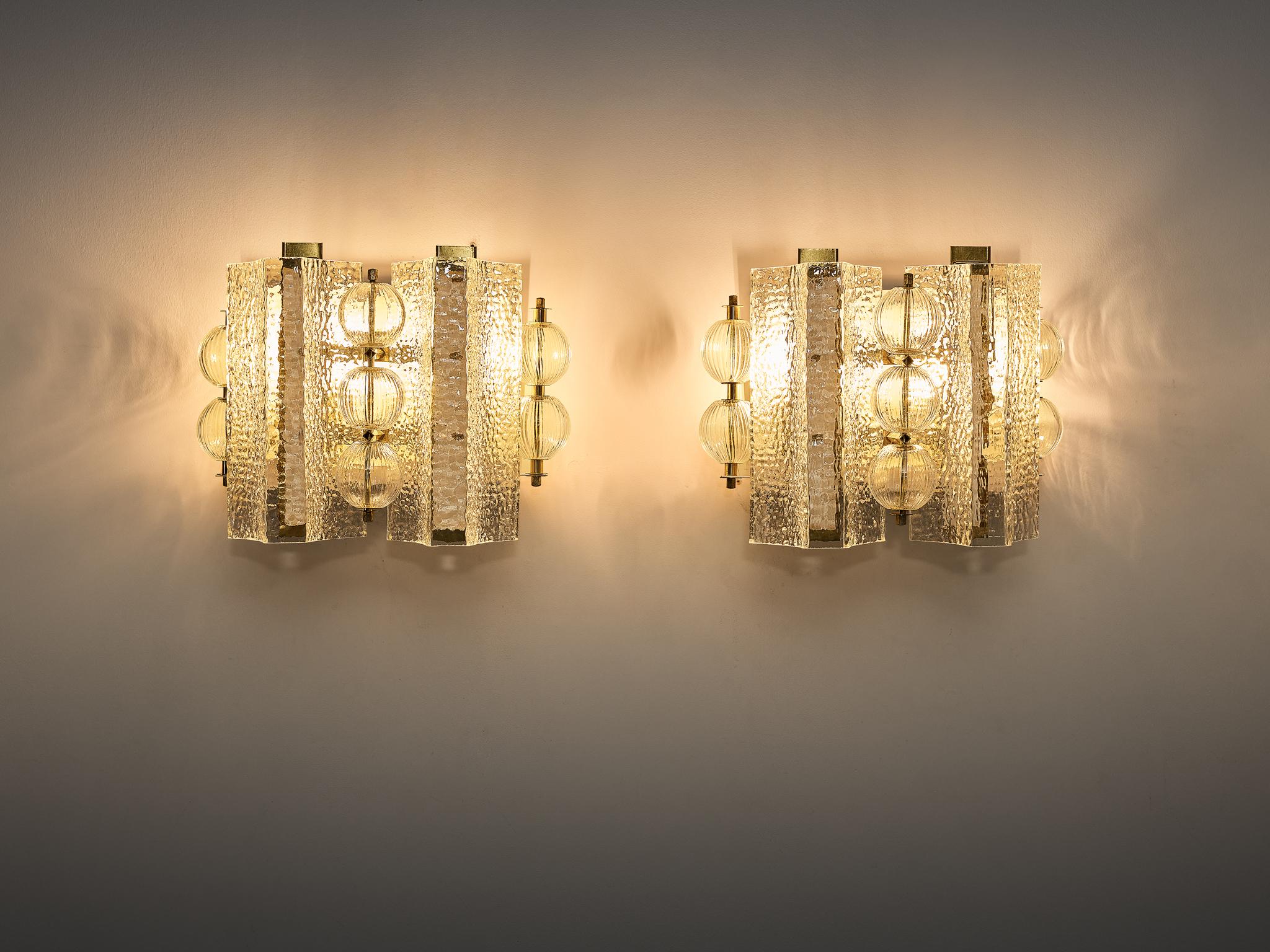 Wall light in glass and brass, Europe, 1970s.

Exquisite wall lights originating from Europe in the 1970s showcase a timeless blend of glass and brass craftsmanship. Featuring glass tubes and spheres alongside dual light points, each adorned with