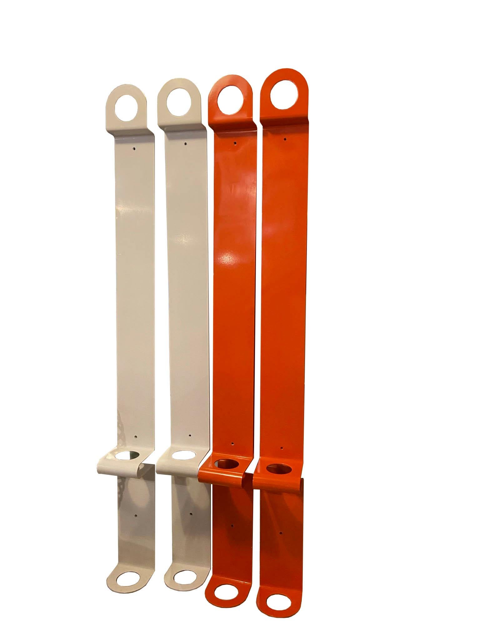 Coat stand consisting of a single round coat hook and an umbrella stand of the same shape. Two white and two orange.