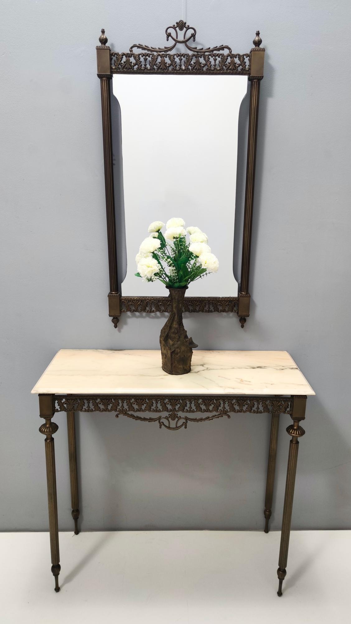 Italy, 1960s.
The console table features a Portuguese pink marble top and both the mirror and the console have a burnished brass frame.
They might show slight traces of use since they are vintage, but they can be considered as in excellent