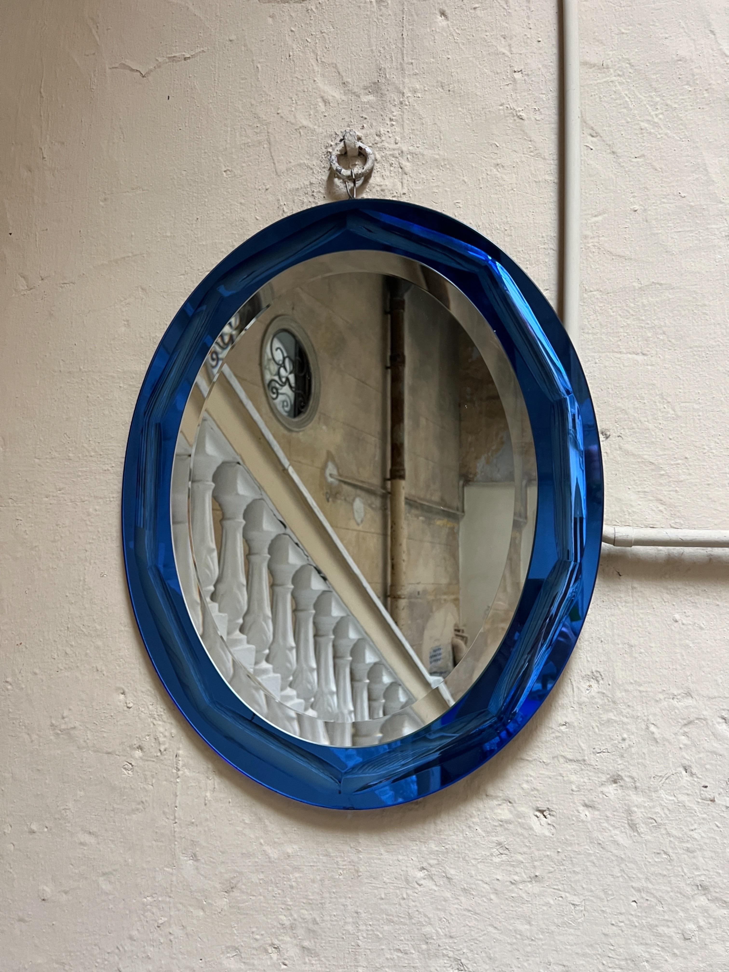 Ein beeindruckender Wandspiegel von Crystal Arte, der in den 1960er Jahren in Turin, Italien, hergestellt wurde.

Dieses außergewöhnliche Stück zeichnet sich durch einen kräftigen, tiefblauen Rahmen mit einer reichlich gealterten Patina aus, die von