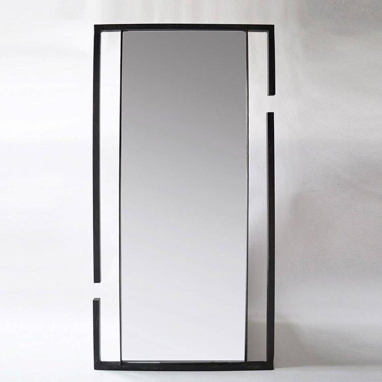 Inspired by two repelling magnets, this mirror is unique in its form and structure. Pictured here as a wall mirror. It can be custom designed to be a standing or vertical mirror.

Handmade in New York.
 