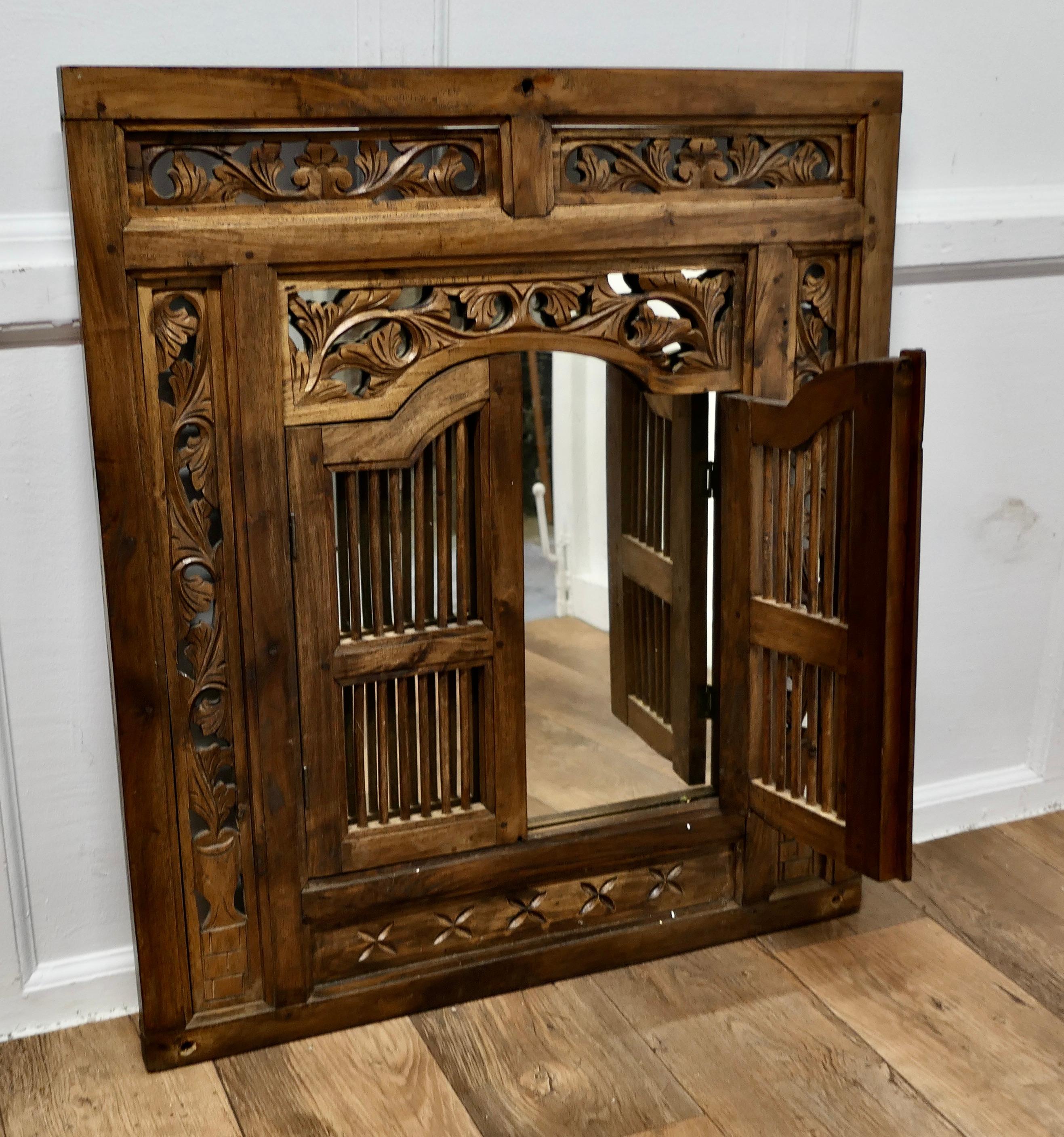 Anglo-Indian Wall Mirror Concealed by Heavy Carved Teak Door Shutters    For Sale