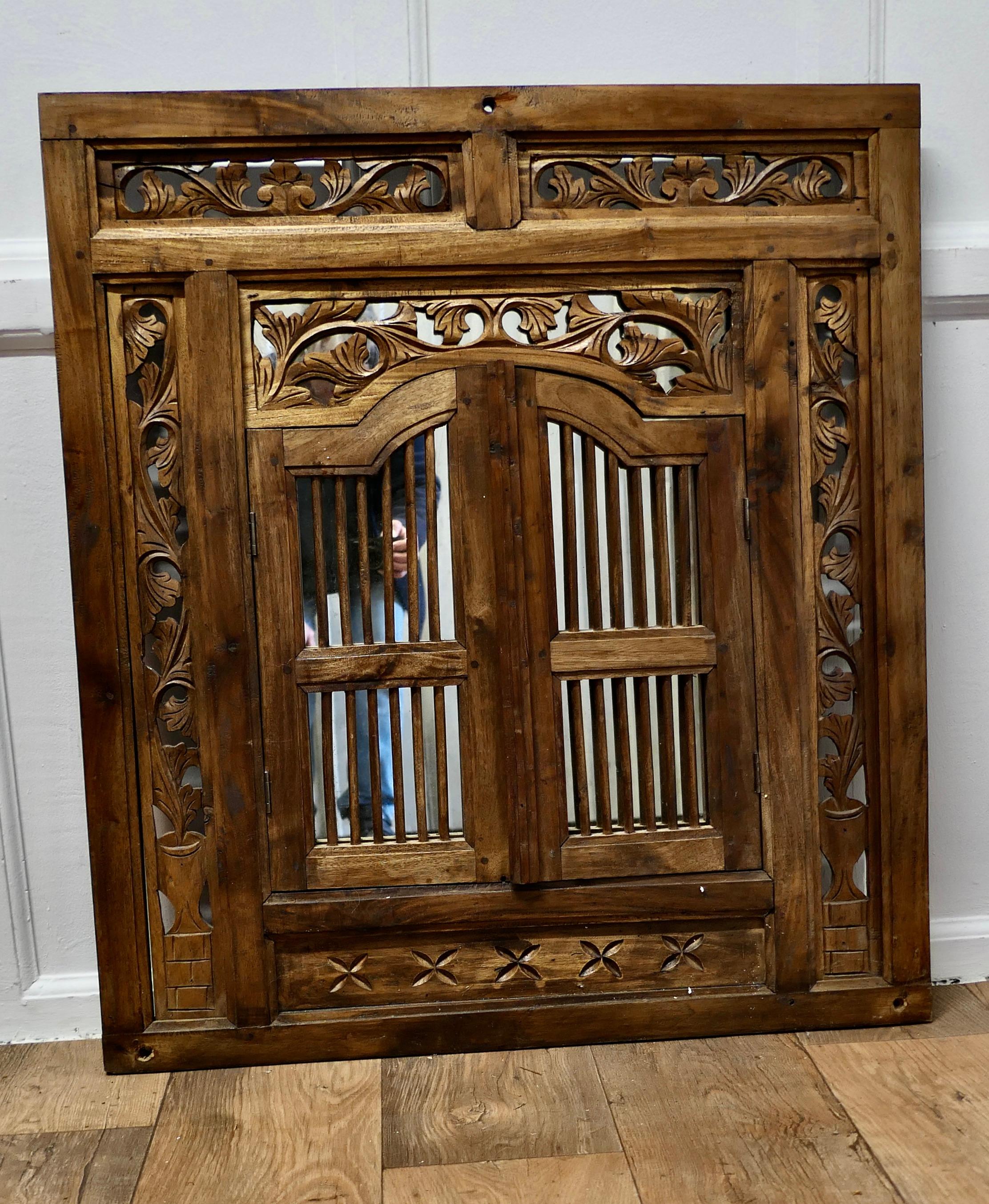 Early 20th Century Wall Mirror Concealed by Heavy Carved Teak Door Shutters    For Sale