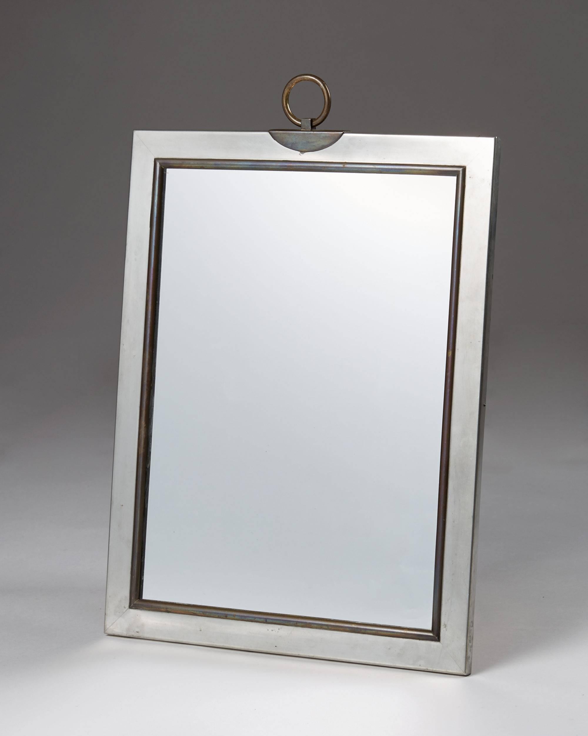 Wall mirror designed by Estrid Ericson for Svenskt Tenn, 
Sweden, 1952.

Pewter and brass.

Measures: H 46.5 cm/ 18 1/4''
W 35 cm/ 13 3/4'.