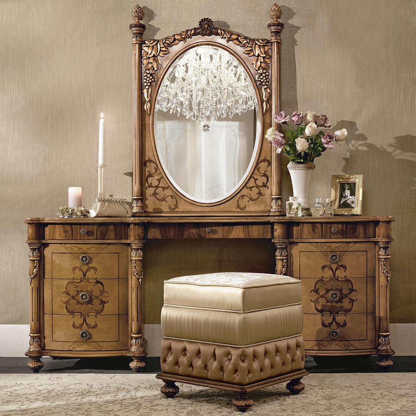 A triumph of fancy, precious decorations, and prized woods, this stunning oval wall mirror was designed to specifically complement the Bianchini's vanity desk. The oval mirror is set into a rectangular wooden frame veneered in a combination of
