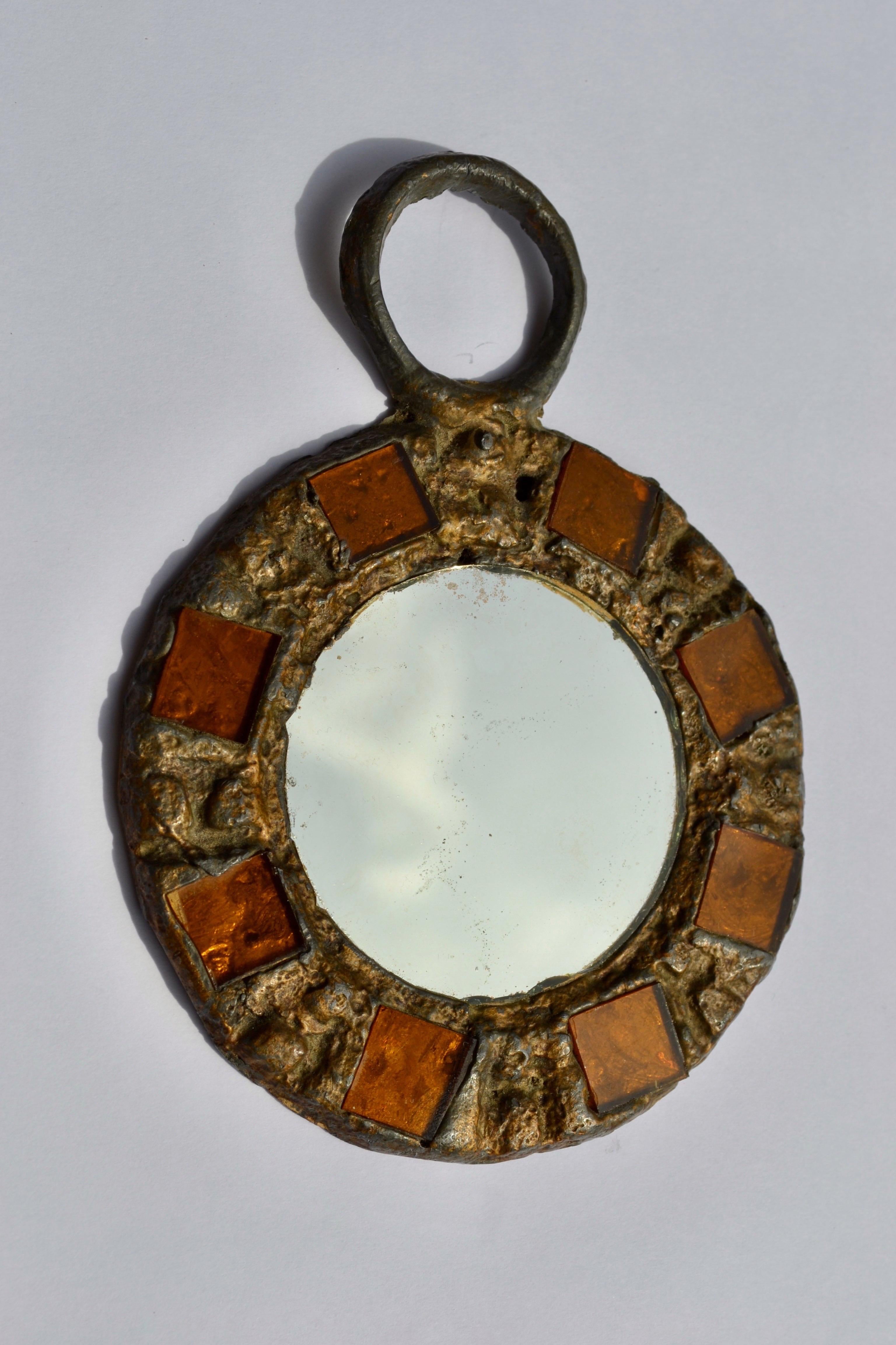 Wall or hand mirror in metal with orange talosel inlays by Irena Jaworska (Line Vautrin School), France, 1970s. This golden mirror is framed in lead, featuring pressed motifs and orange-toned talosel inlays surrounding a round mirror. Irena Jaworska