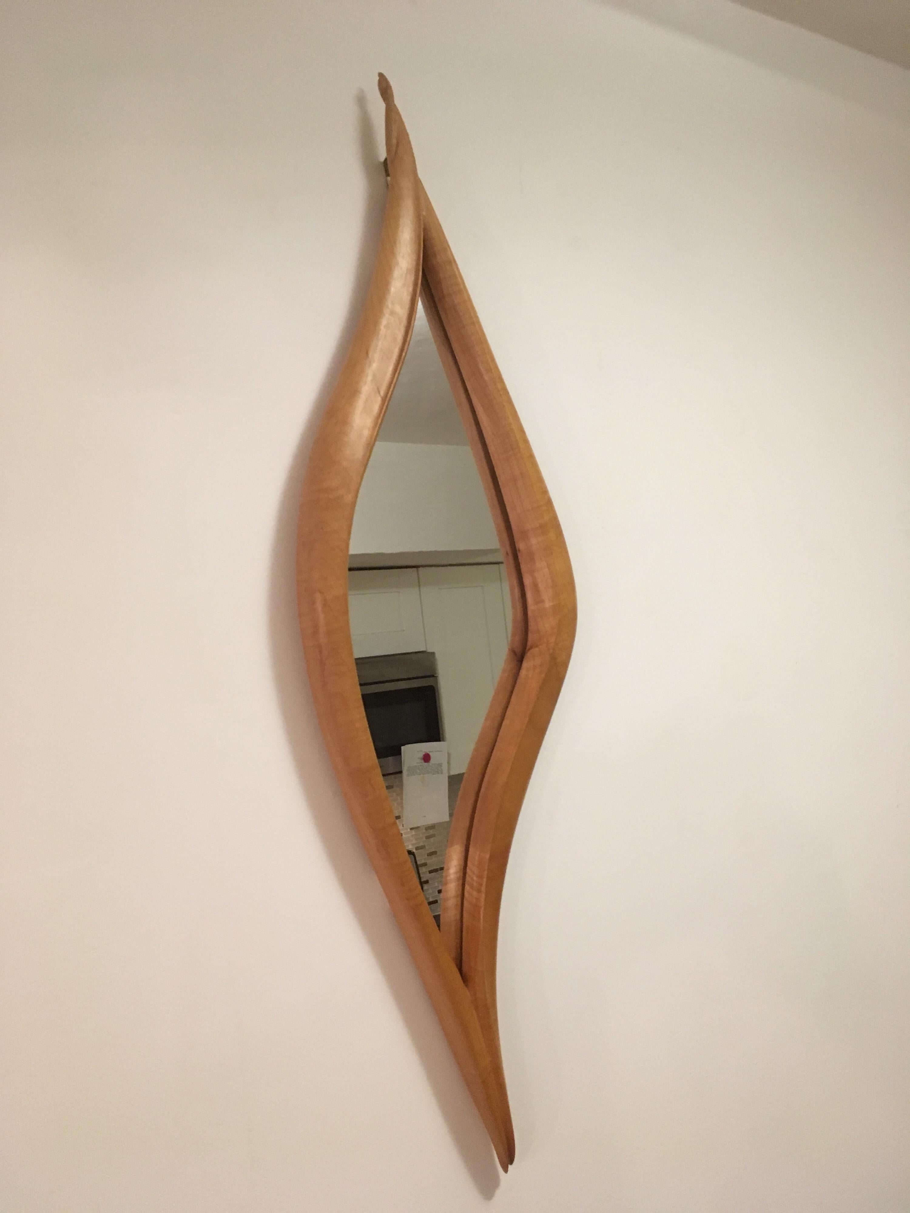 Magnifique miroir mural en bois sculpté.