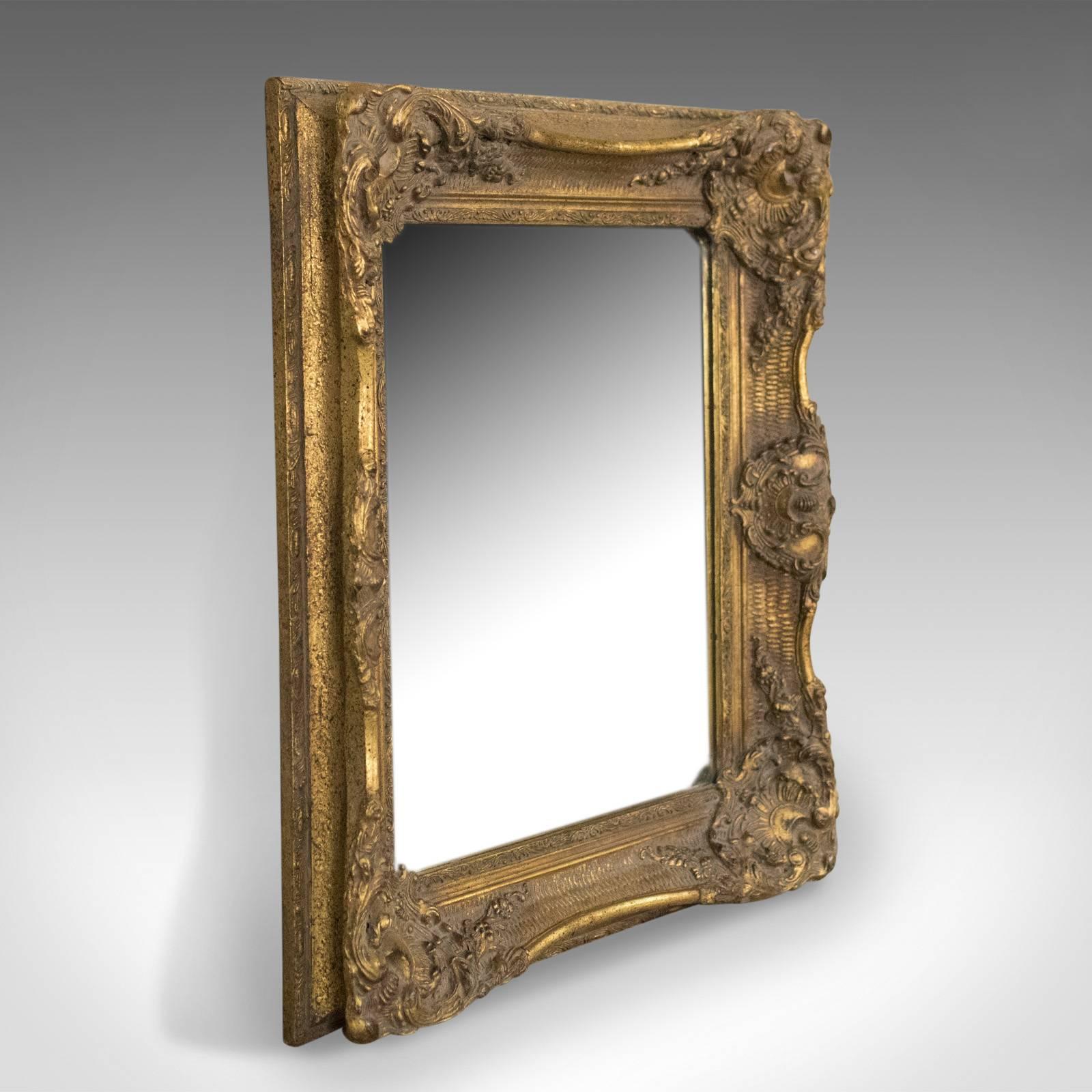 This is a wall mirror in the Victorian classical revival taste in giltwood and dating to the latter half of the 20th century.

An attractive revival piece in a gilt gesso frame
Late 20th century in the Victorian classical taste
Decorated with