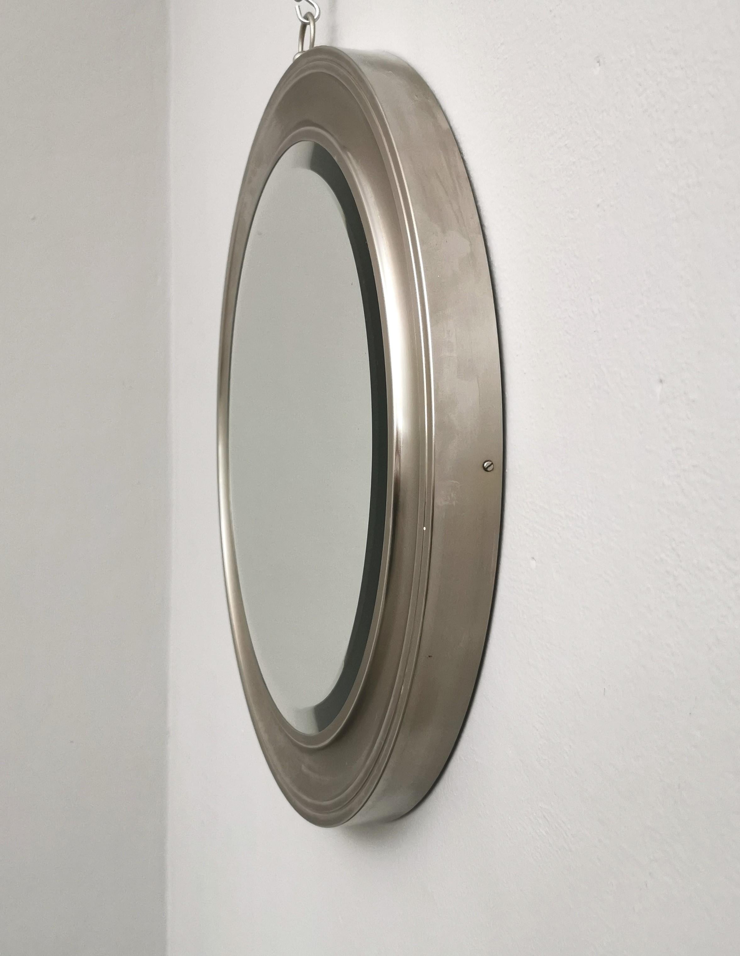 Wall mirror designed by the Italian designer Sergio Mazza and produced in the 60's by his company Artemide. The round-shaped mirror was made entirely of galvanized metal, with a glass in the center with a ground edge that creates a sense of depth.