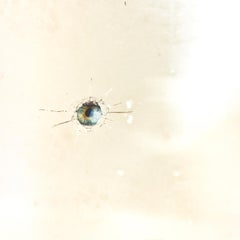 Wall Mirror with Bullet Holes Hiding Colored Eyes in an Antique Gilded Frame