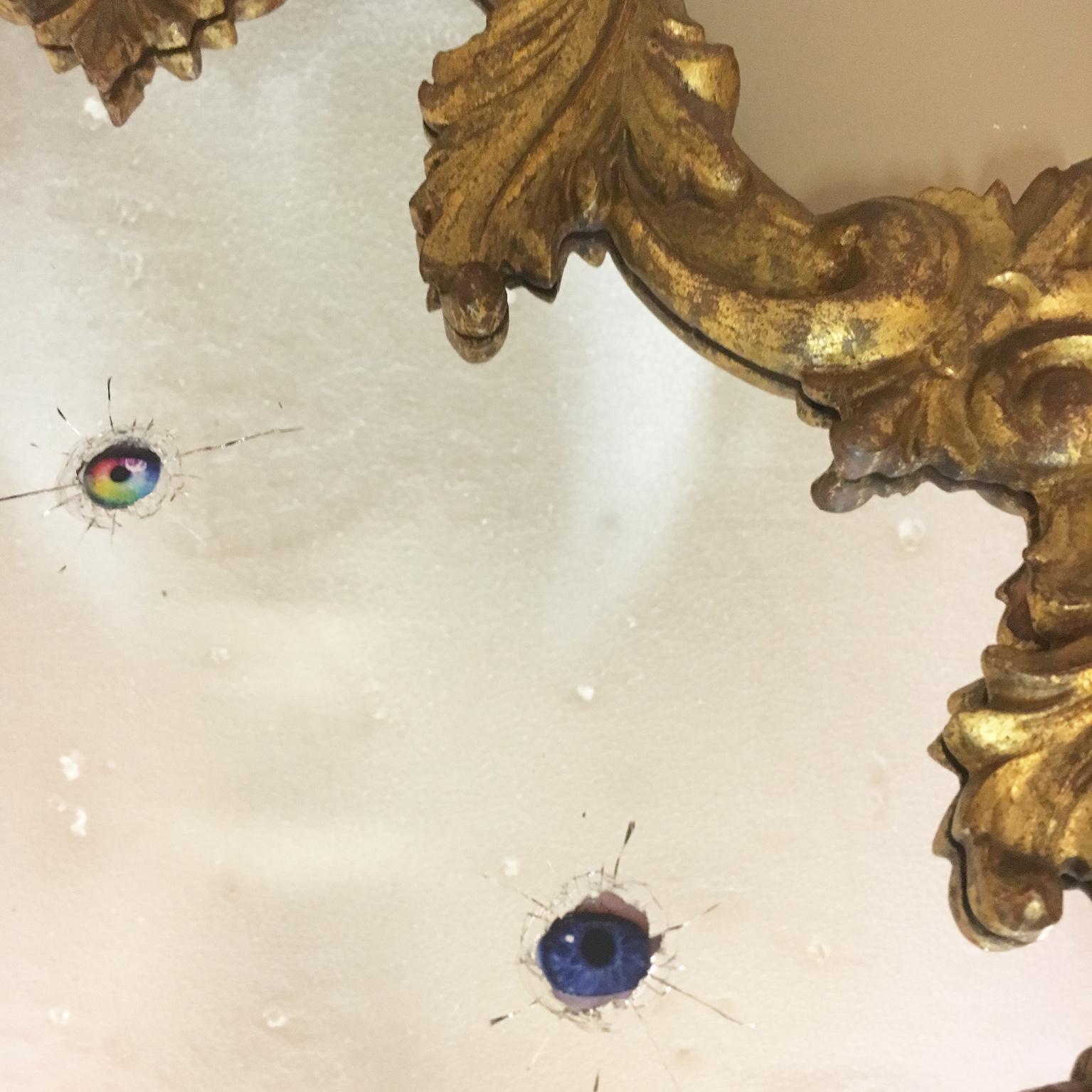 Italian Wall Mirror with Bullet Holes Hiding Colored Eyes in an Antique Gilded Frame For Sale