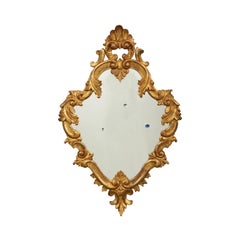 Wall Mirror with Bullet Holes Hiding Colored Eyes in an Antique Gilded Frame
