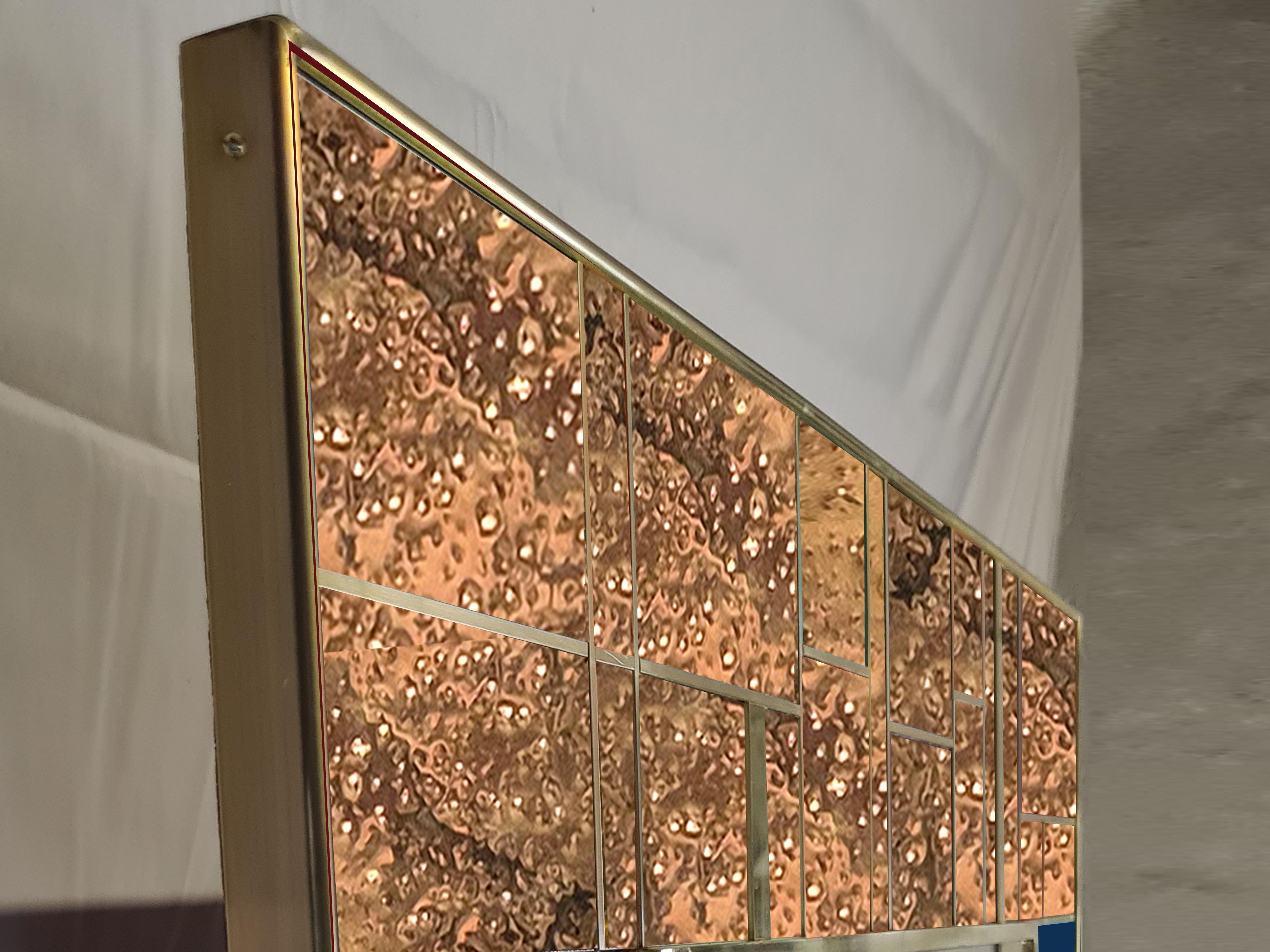This refined wall mirror in dotted brass and blue Murano glass showcases the elegance of Italian design. 

Made of solid birch wood, the rectangular frame is adorned with intricate L-dotted brass accents that highlight its modern aesthetic. Gorgeous
