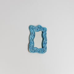 Wall mirror with light blue ceramic frame