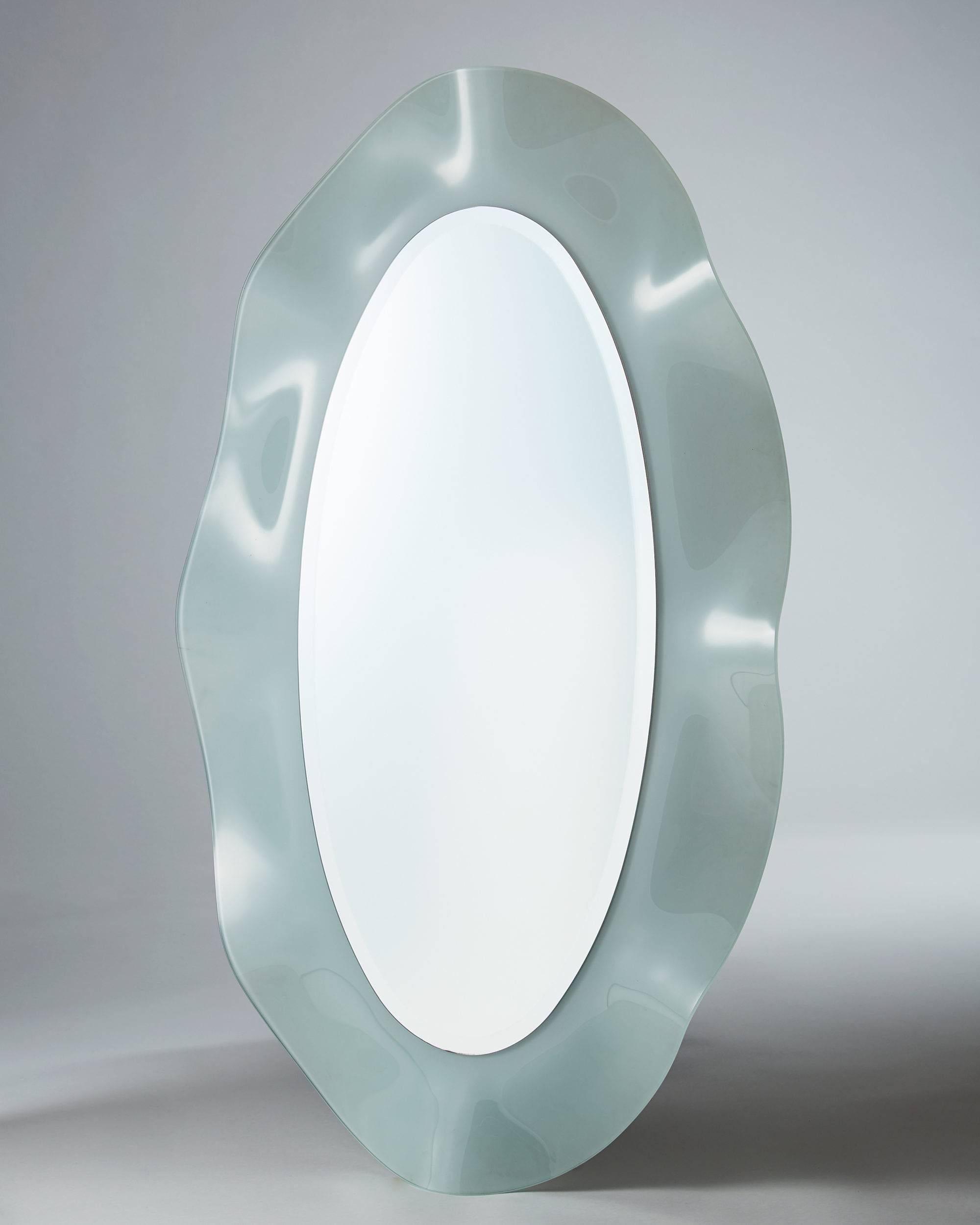 Wall mirror, 
Italy, 1980s.

Milk glass and mirrored glass.

Measures: H 125 cm/ 4' 1 1/4''
W 76 cm/ 30''.