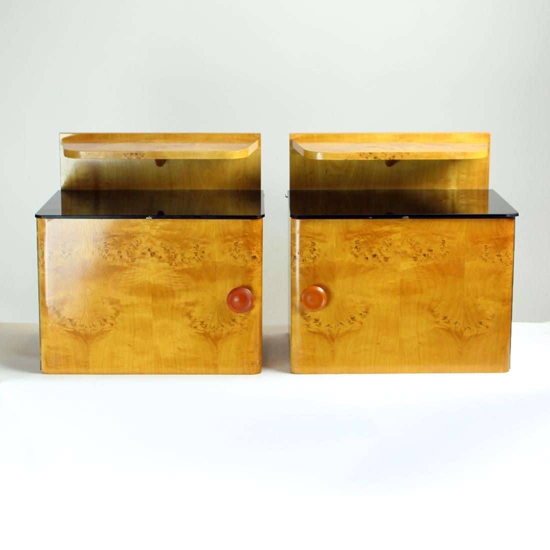 Beautiful set of two bedside tables. Produced in Czechoslovakia in 1940s, the art deco period. The tables are made of strong oak wood with veneer on top. Each table has a compartment with mirror-opening doors on piano hindges. Inside there is one