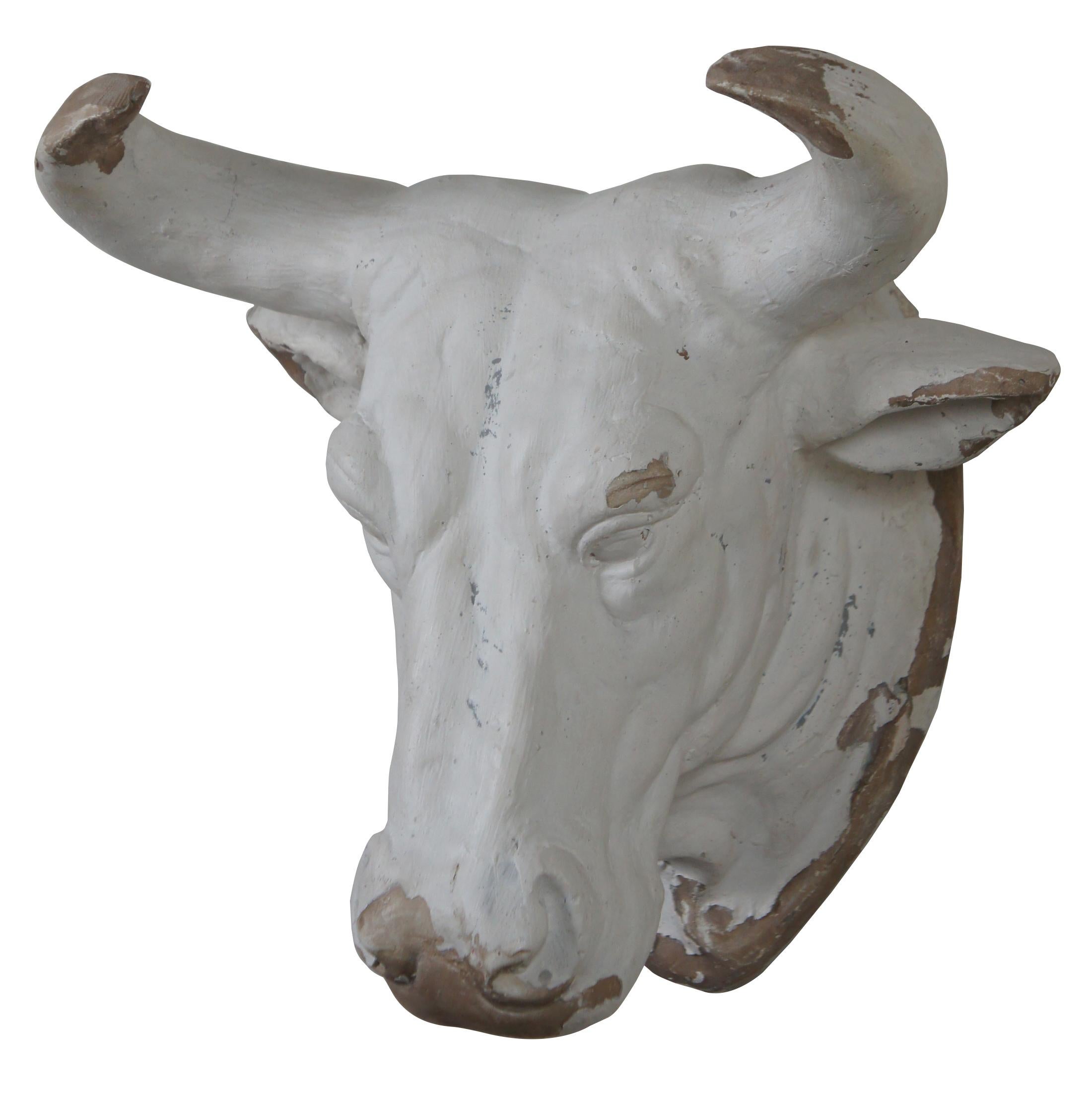Realistic composite ceramic bull head wall hanging, finished with a rustic, artistically distressed white glaze.
 