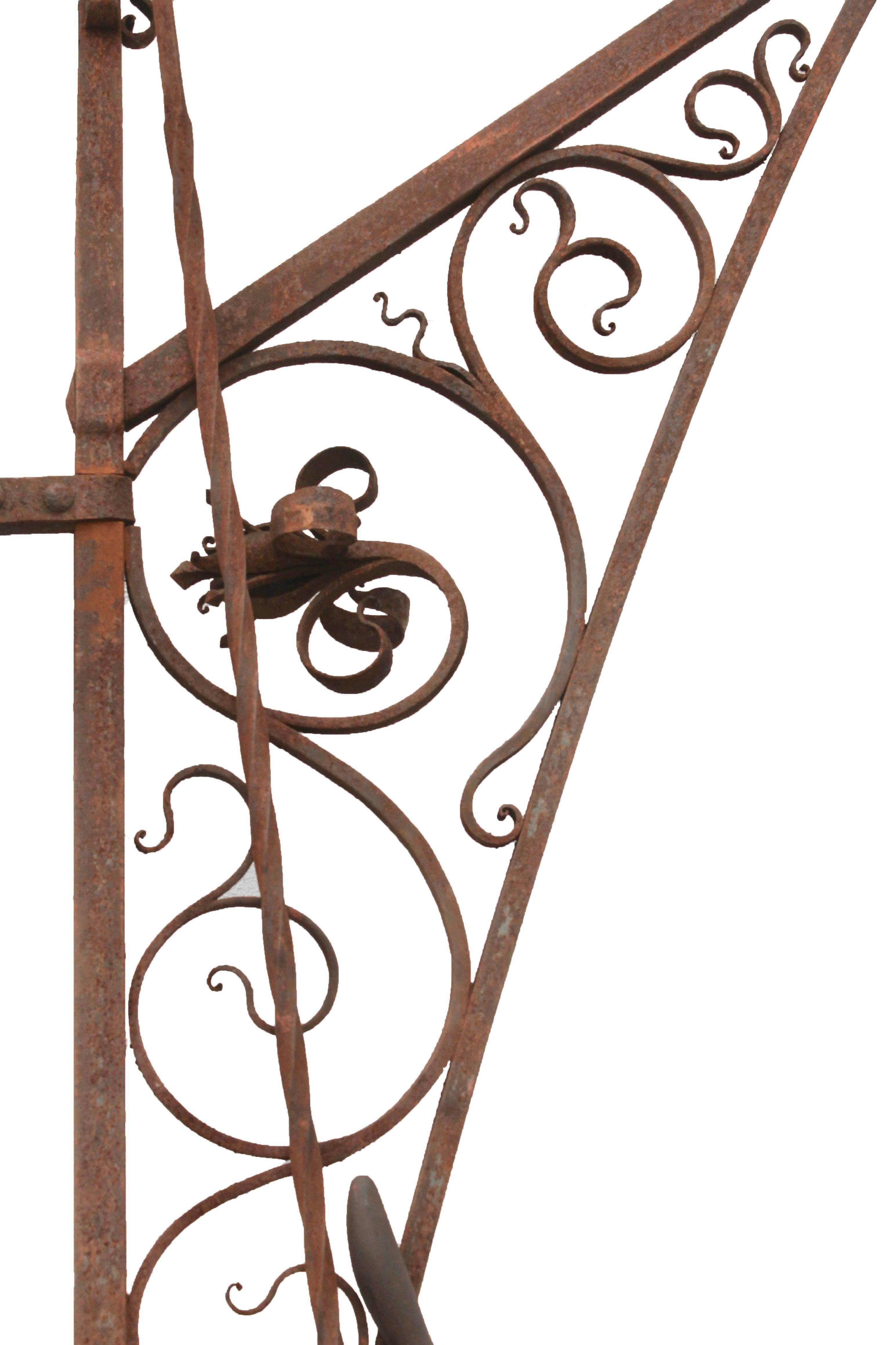 Wall mountable carriage lantern hook with handle and lever for easy access.
This decorative ironwork mounts onto any wall. Pulling the lever will bring down the hook so that you can light an oil lantern, and returning the lever will raise it back