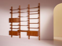 Wall-mounted bookcase with wooden uprights and modules, Italy, 1950s