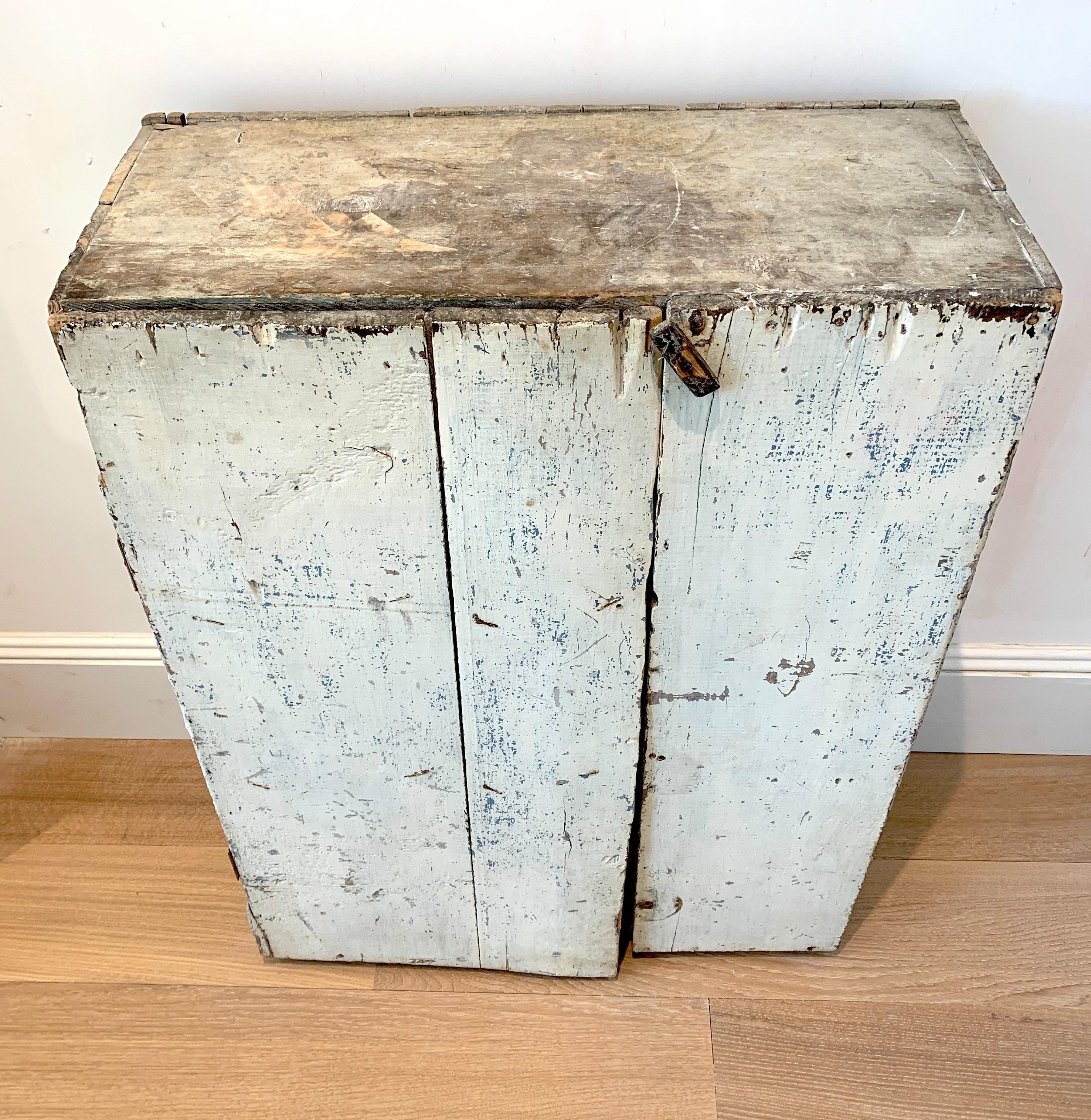 American Folk-Art Primitive, this cabinet features an authentic patina of distressed white over light blue hues. All wood inside. Hinges and clasp are functional. Dress it up with new hardware or use it as-is. Once mounted it is sturdy and solid.