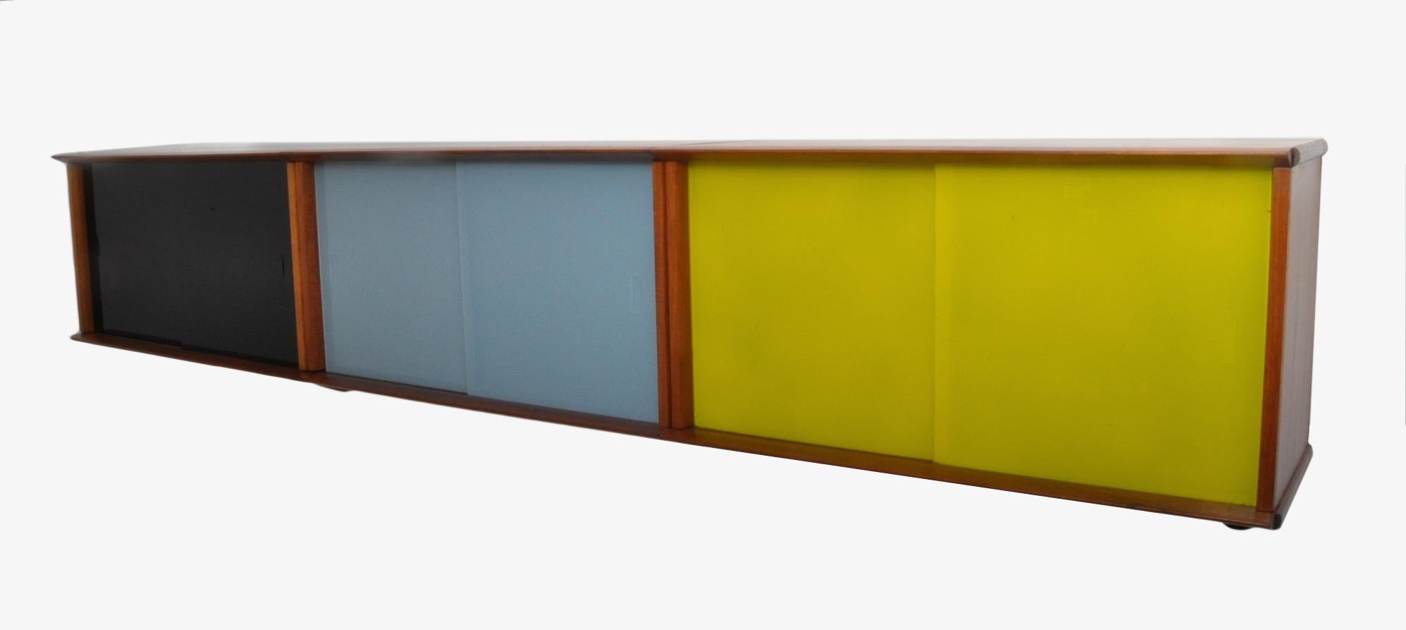 Modular wall cabinet designed by Didier Rozaffy for Oscar Paris. The entire cabinet can be broken down then reassembled on location. The cabinet retains the original colorful glass sliding doors.