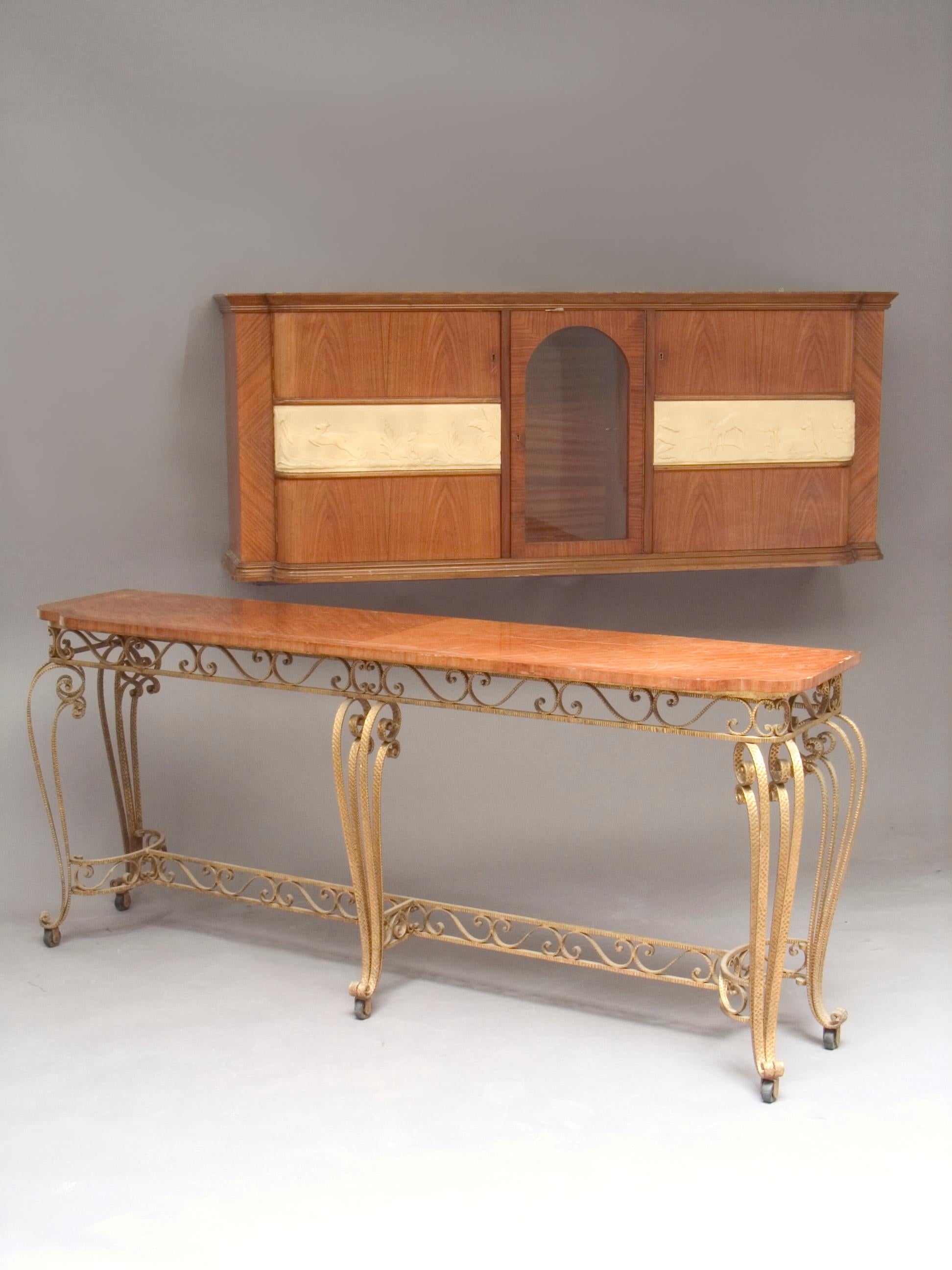 This is a rare ensemble consisting of a wall-mounted cabinet and a movable console table, both designed by Francesco Bisacco. This modernist wall system has an architectural order which returns to its vernacular origins. Its composition follows an