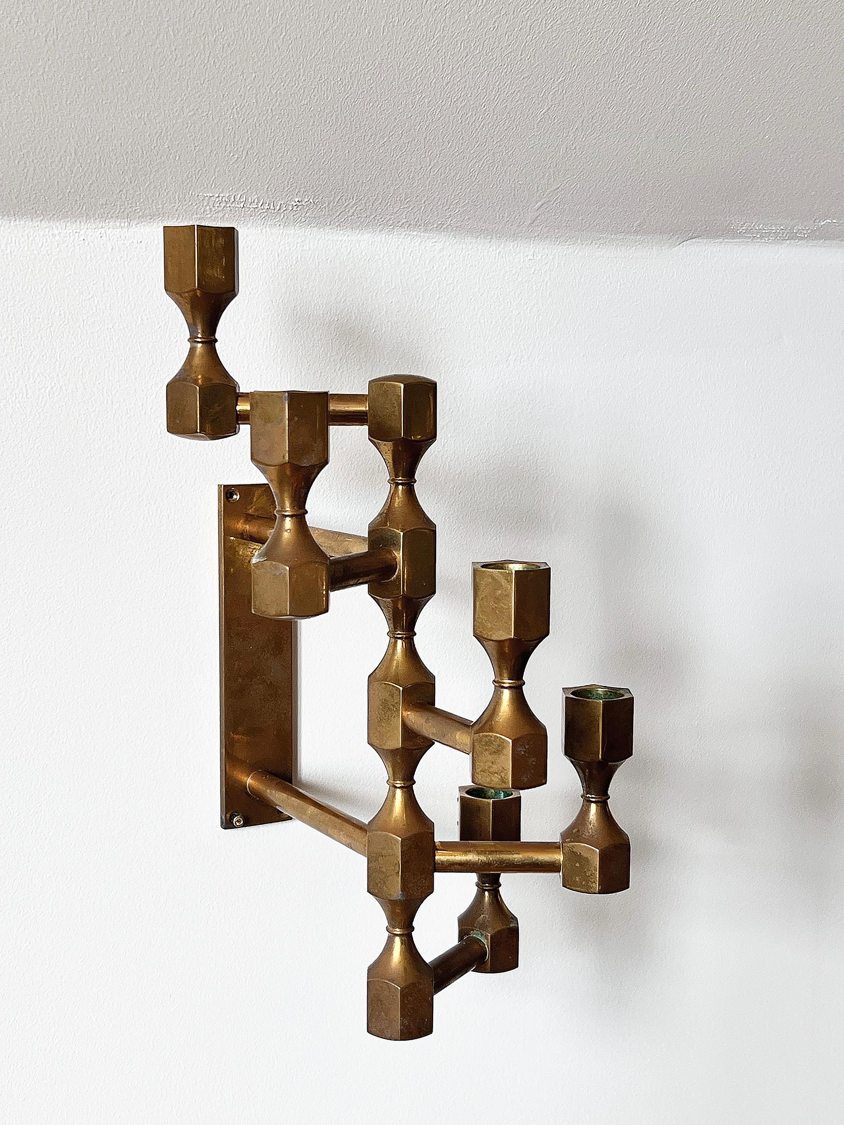 Beautiful wall mounted candelabra in bras by Metallslöjden Gusum -1982, Sweden. 
Condition: good, wear consistent with age and use. Brass patina. 
