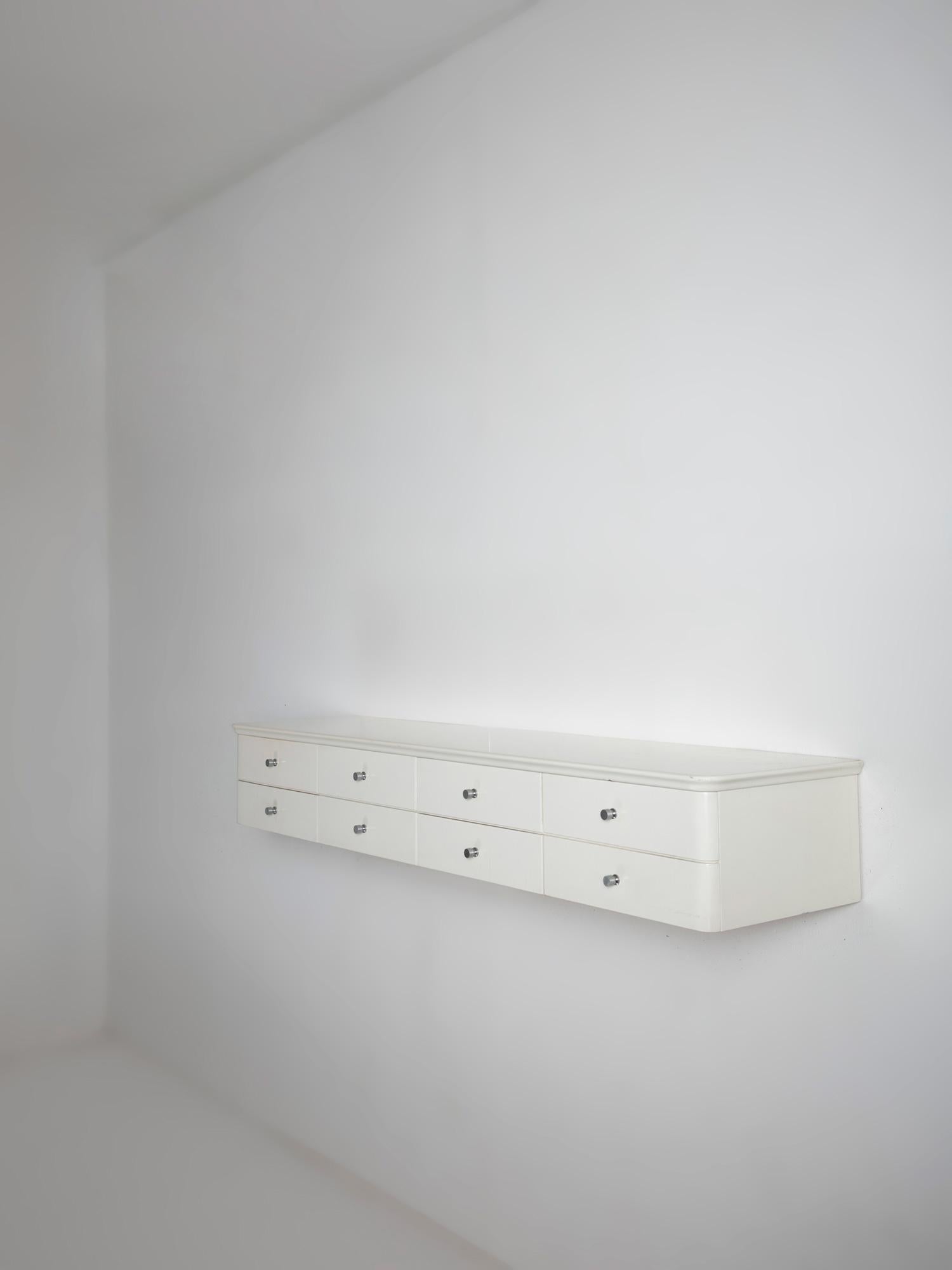 Italian 60s white lacquered shelf with eight drawers.