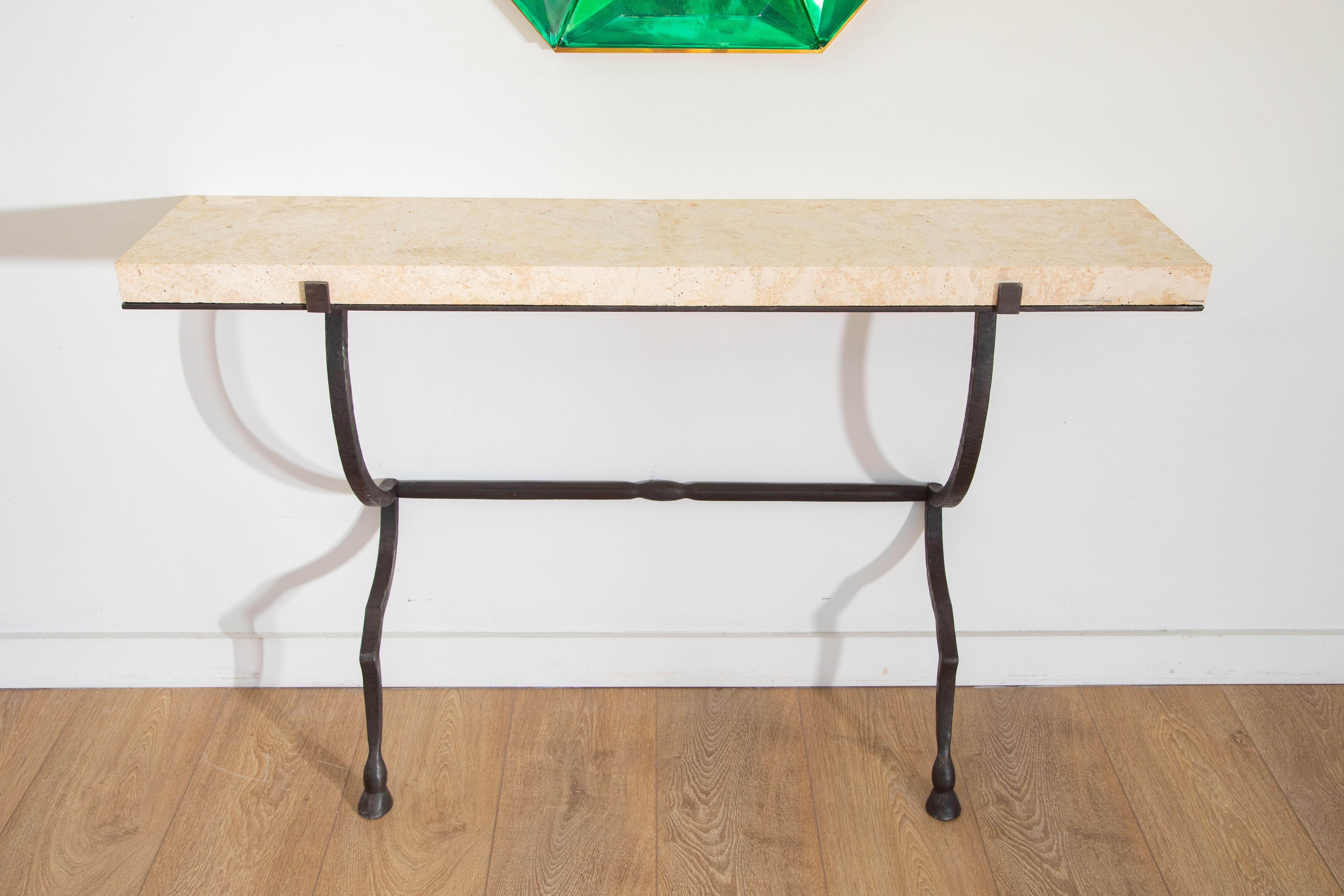 Wall-mounted console hammered metal with thick coral stone top, in stock
Hammered and hand-forged metal structure with hoof feet
Thick coral stone (1 inch 3/4)
Black fired patina
Console easily mounts to the wall with screws
Pair available (priced