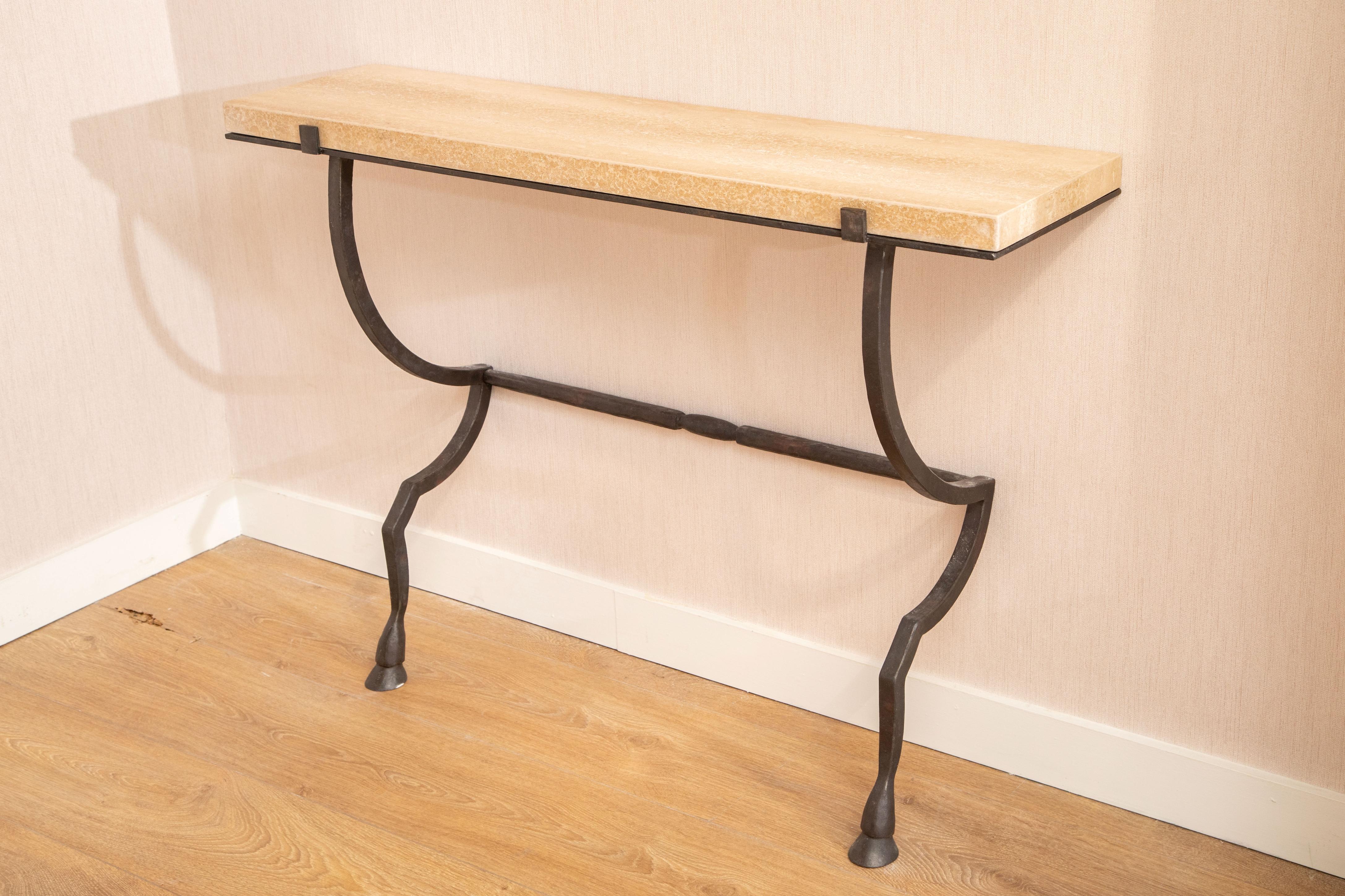 Wall-mounted console hammered metal with travertine top, in stock
Hammered and hand-forged metal structure with hoof feet
Black fired patina frame
Console easily mounts to the wall with screws
Pair available (priced individually)
Available to view