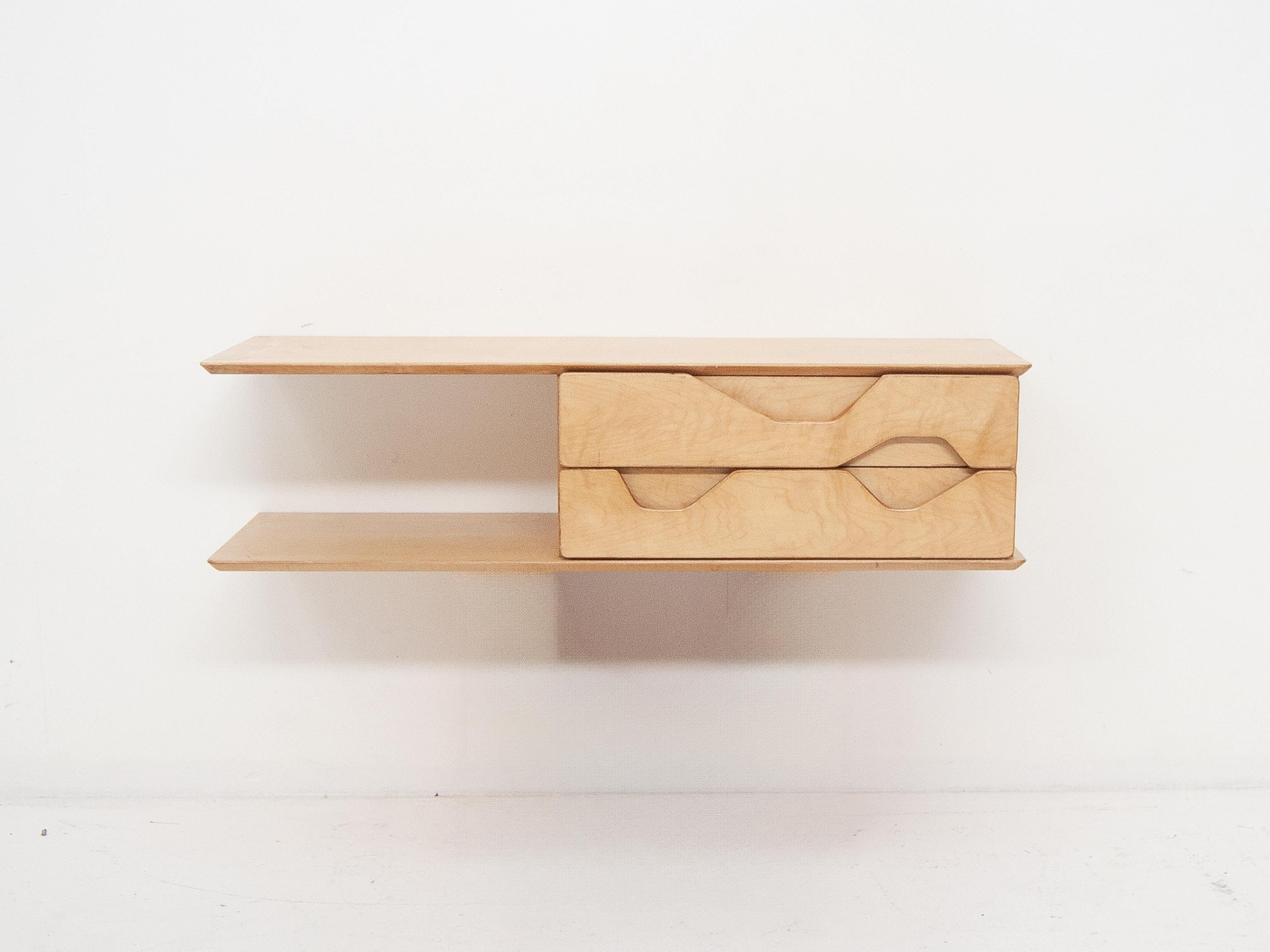 Wall-mounted wooden chest of drawers by Gio Ponti, 1950s, featuring the same distinctive shape as the renowned model with brass feet designed for the Royal Hotel in Naples
Very good vintage condition. Wood shows signs of wear and age throughout.  