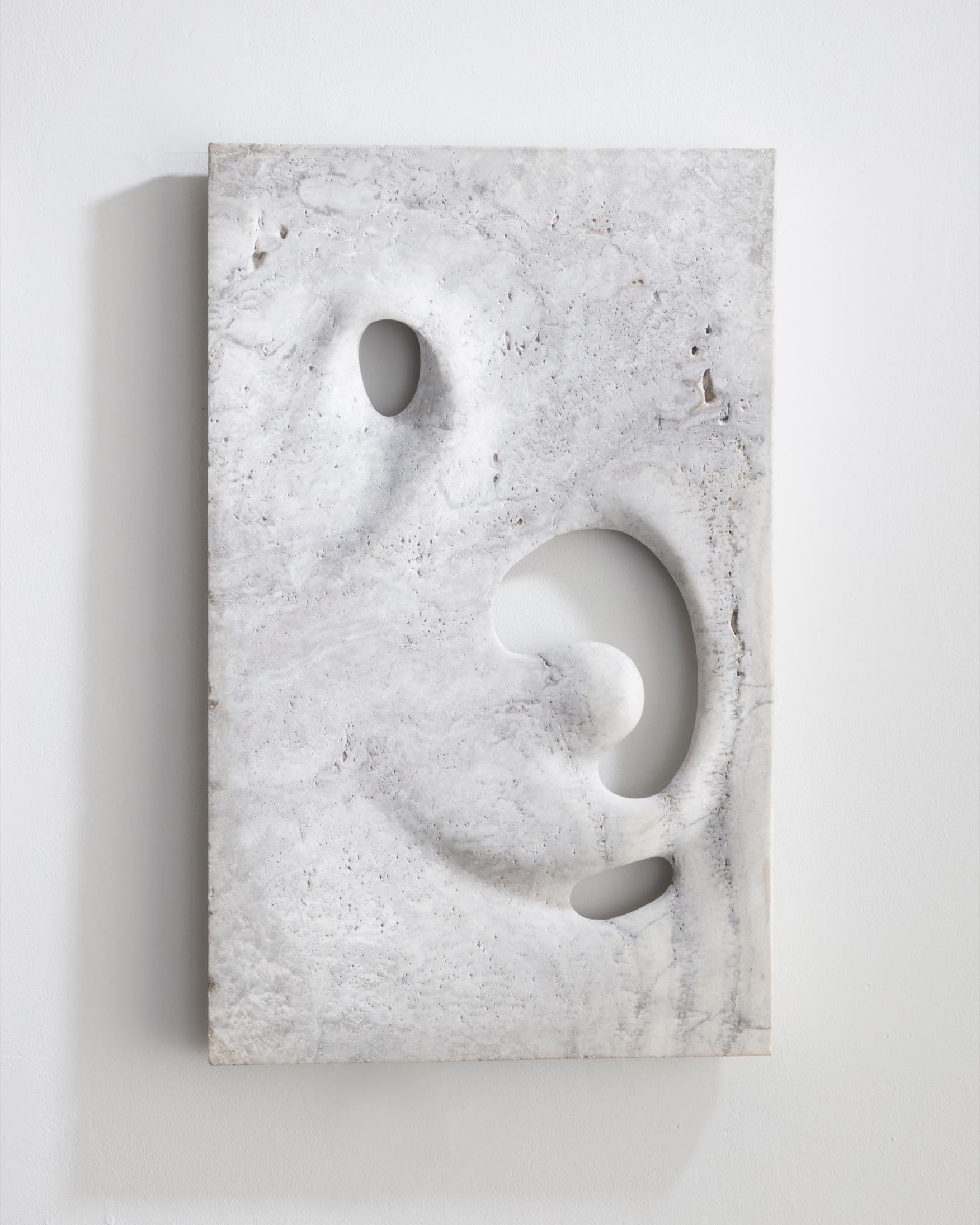 Unique wall-mounted illuminated sculpture in hand carved white travertine. Designed and made by Rogan Gregory, USA, 2016.
 