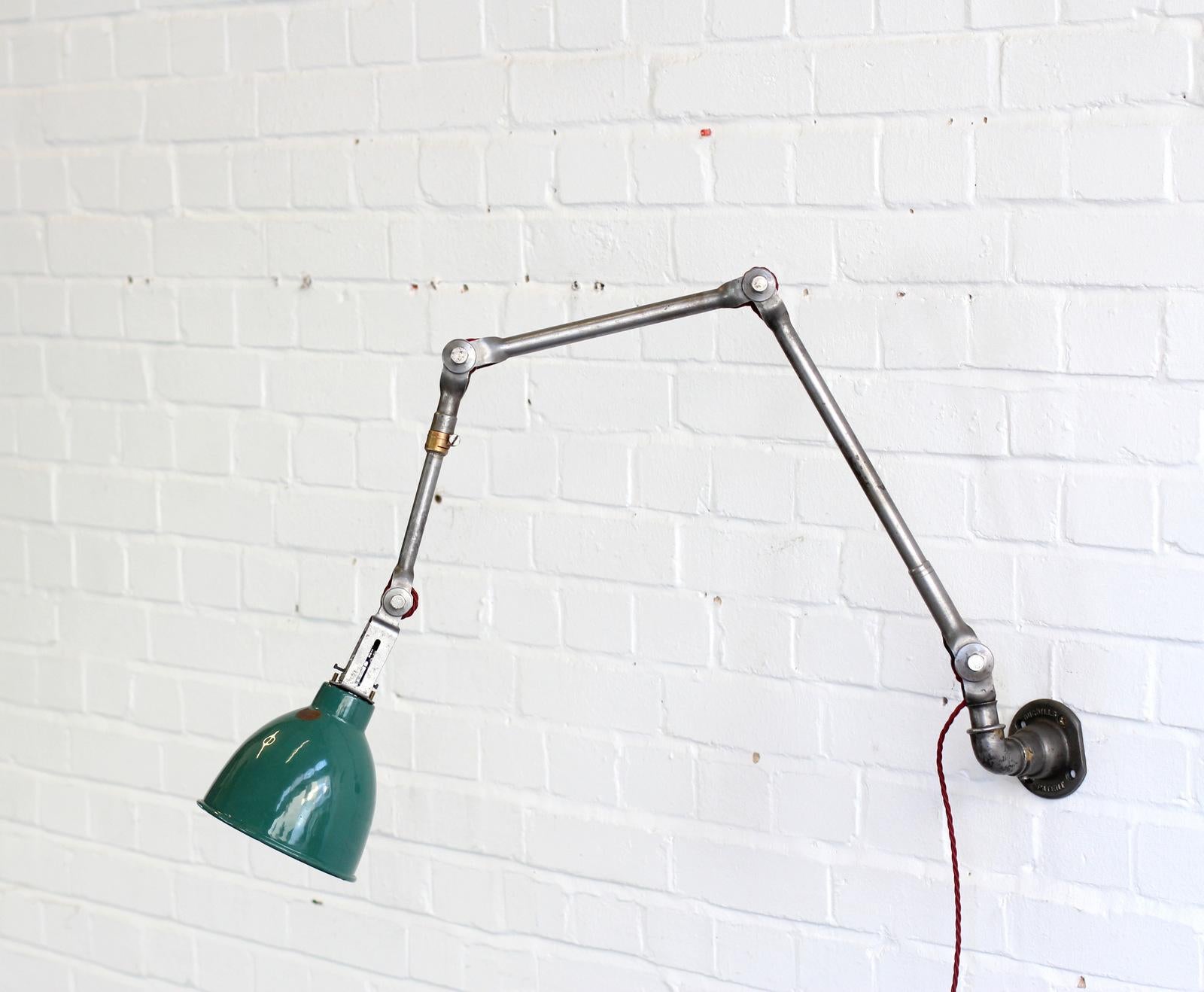 Wall-mounted Industrial lamp by Dugdills, circa 1940s

- Vitreous green enamel shade
- Brushed steel articulated arms
- Takes B22 fitting bulbs
- English, circa 1940s
- Extends up to 100 cm from the wall
- Shade measures 16 cm