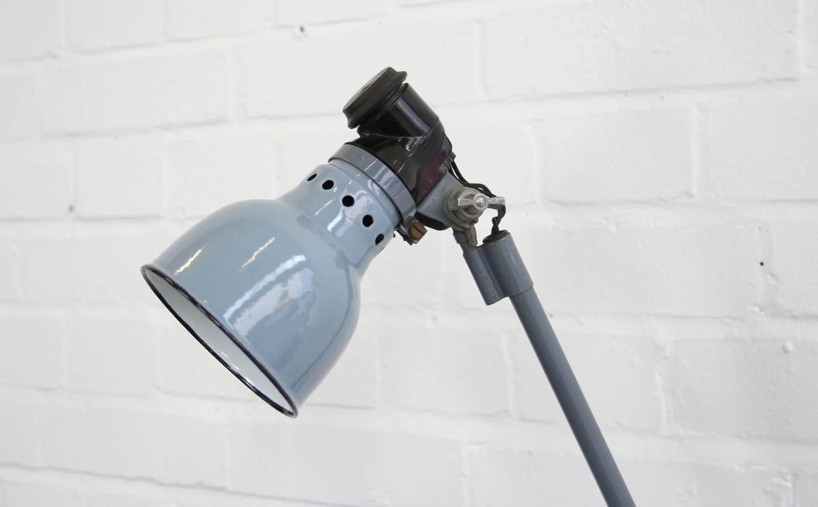Wall mounted industrial lamp by Ernst Radermacher, circa 1930s.

- Vitreous grey enamel shade
- Black bakelite switch with Embossed 