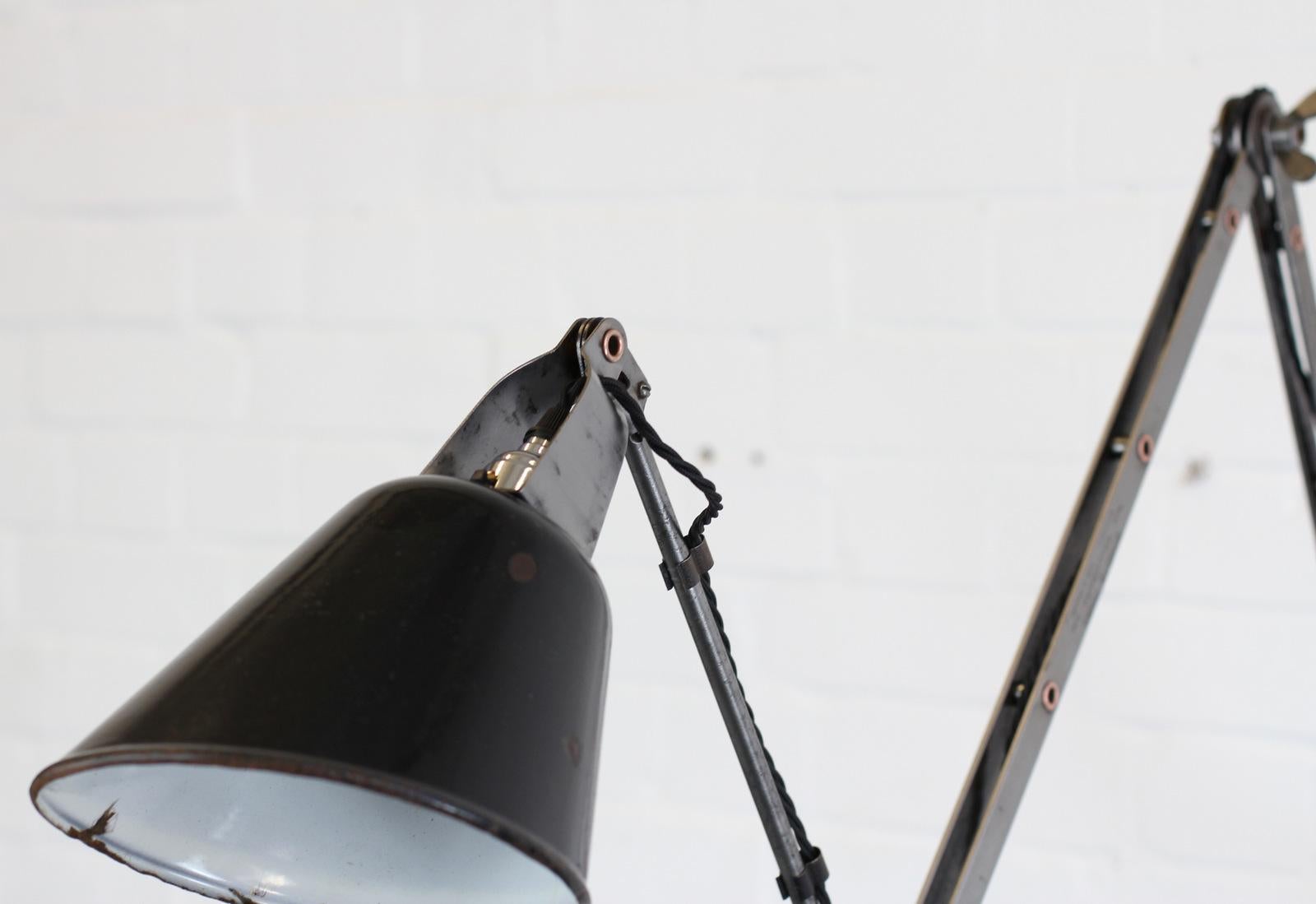 Wall-mounted Industrial lamp by Walligraph, circa 1930s

- Sharp angled shade
- Vitreous black enamel shade
- 3 articulated arms
- Embossed makers marks on each arm
- Takes B22 fitting bulbs
- On/off switch on the head
- English, circa