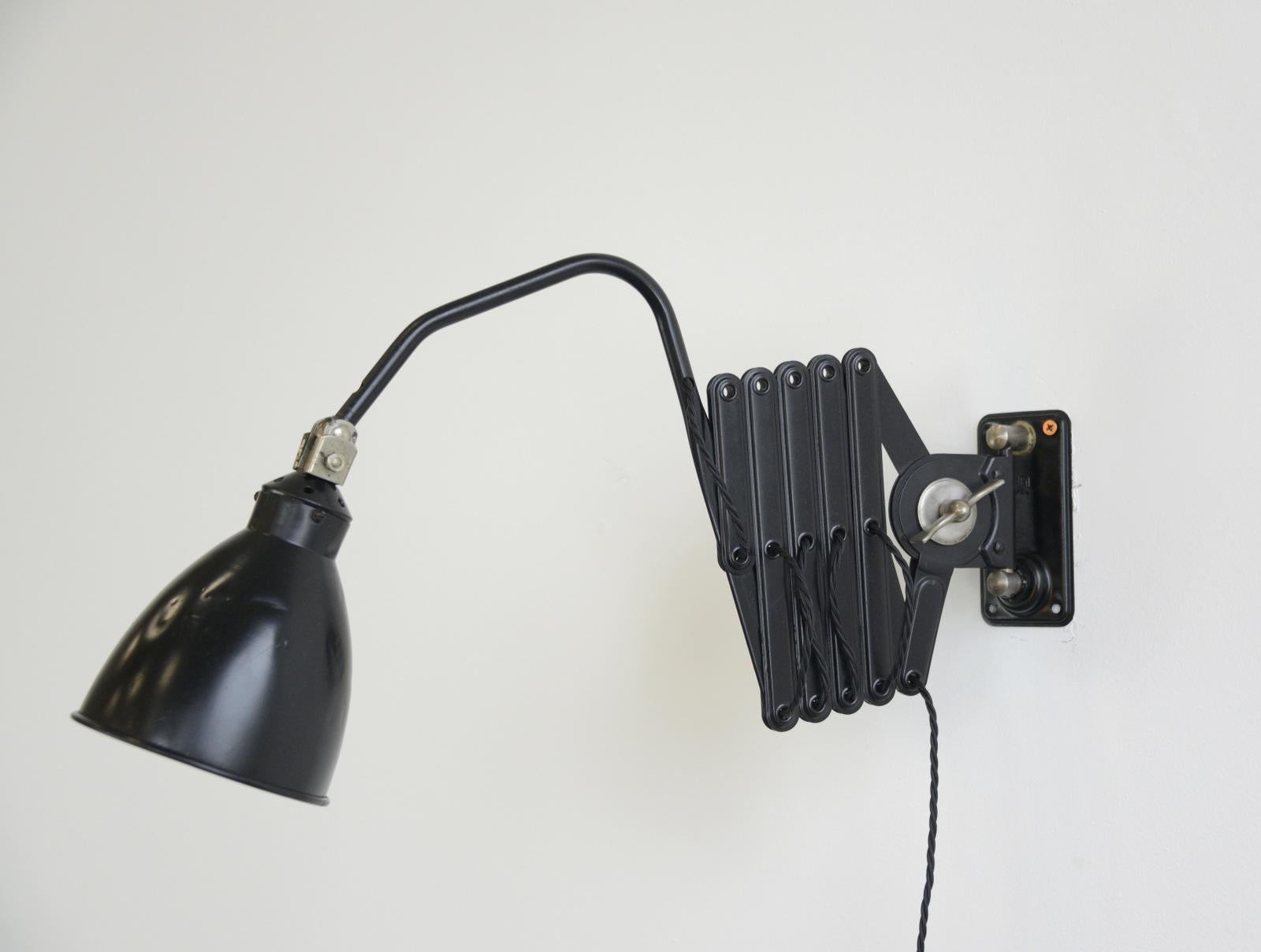 Wall mounted industrial scissor lamp by AGI, circa 1930s

- Fully rewired
- Takes E27 fitting bulbs
- Steel scissor mechanism with aluminium shade
- Belgian, circa 1930s
- Shade measures 16cm x 16cm
- Scissor extends 60cm - 110cm from the