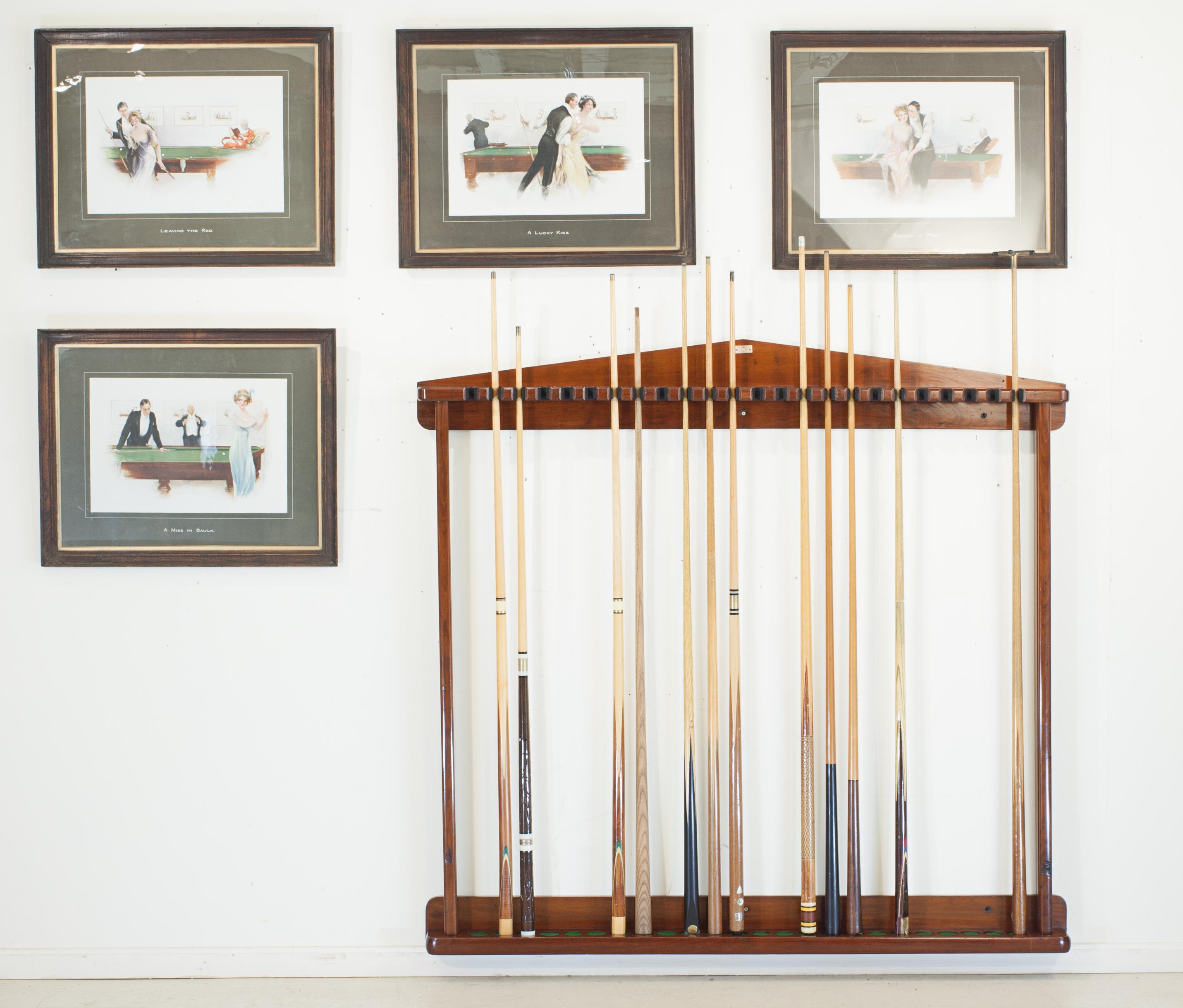 Wall mounted cue rack.
A large wall mounted antique billiards, snooker, or pool cue rack constructed from mahogany. The rack will hold twenty four cues and rest and clip in the slots at the top. The slots have been fitted with foam to keep the cues